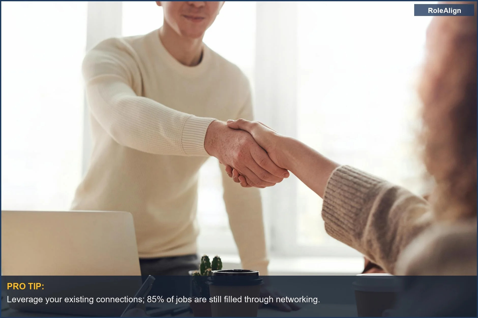Professionals shaking hands, illustrating the power of human networking in job searches.