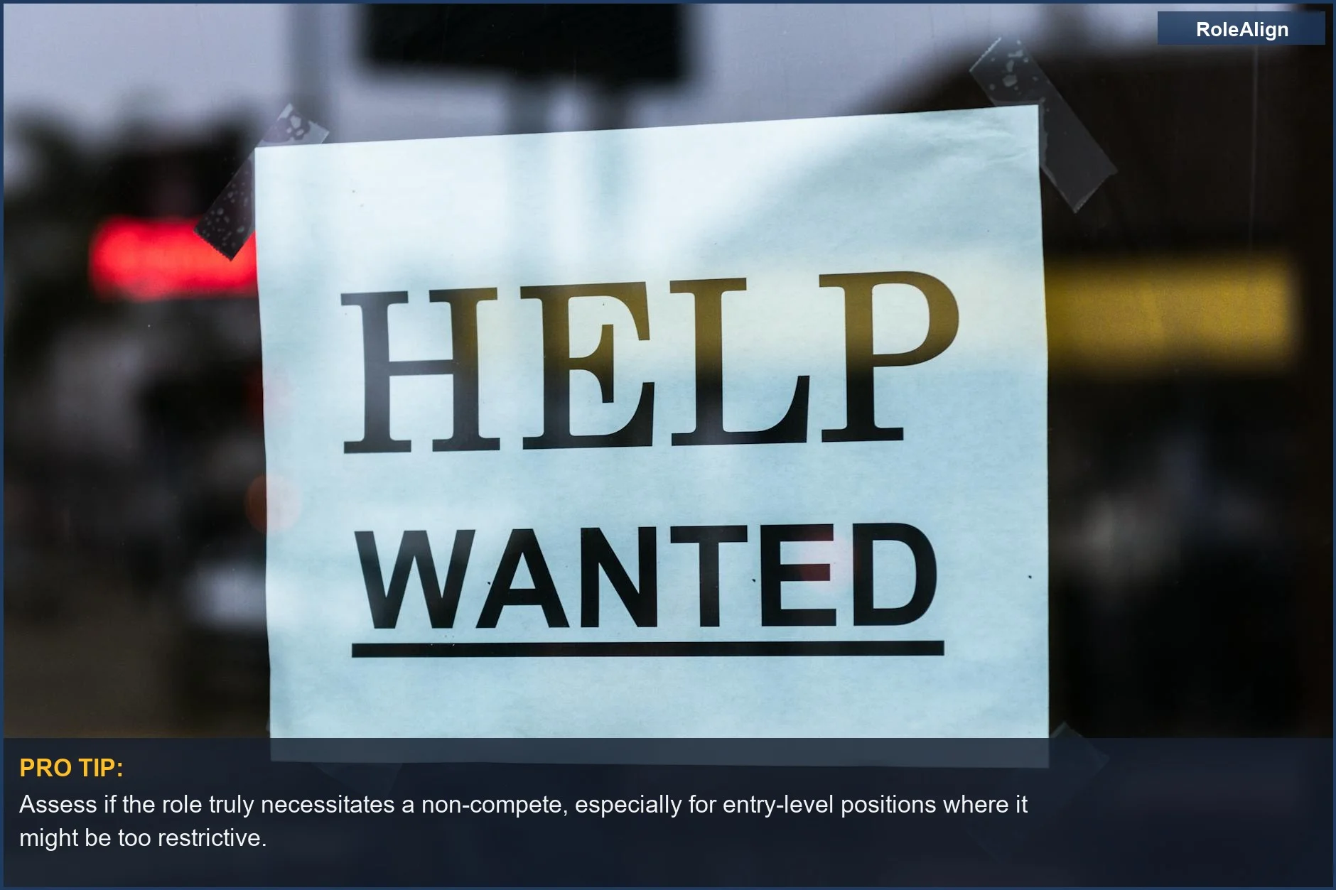 Help Wanted sign on a storefront window, questioning the necessity of non-compete agreements for all roles.
