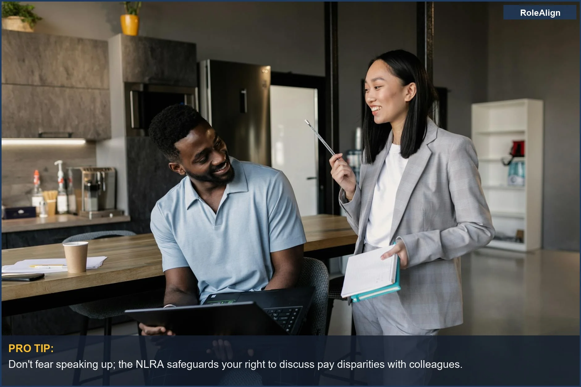 Professional coworkers in a modern office having a friendly discussion about workplace matters.