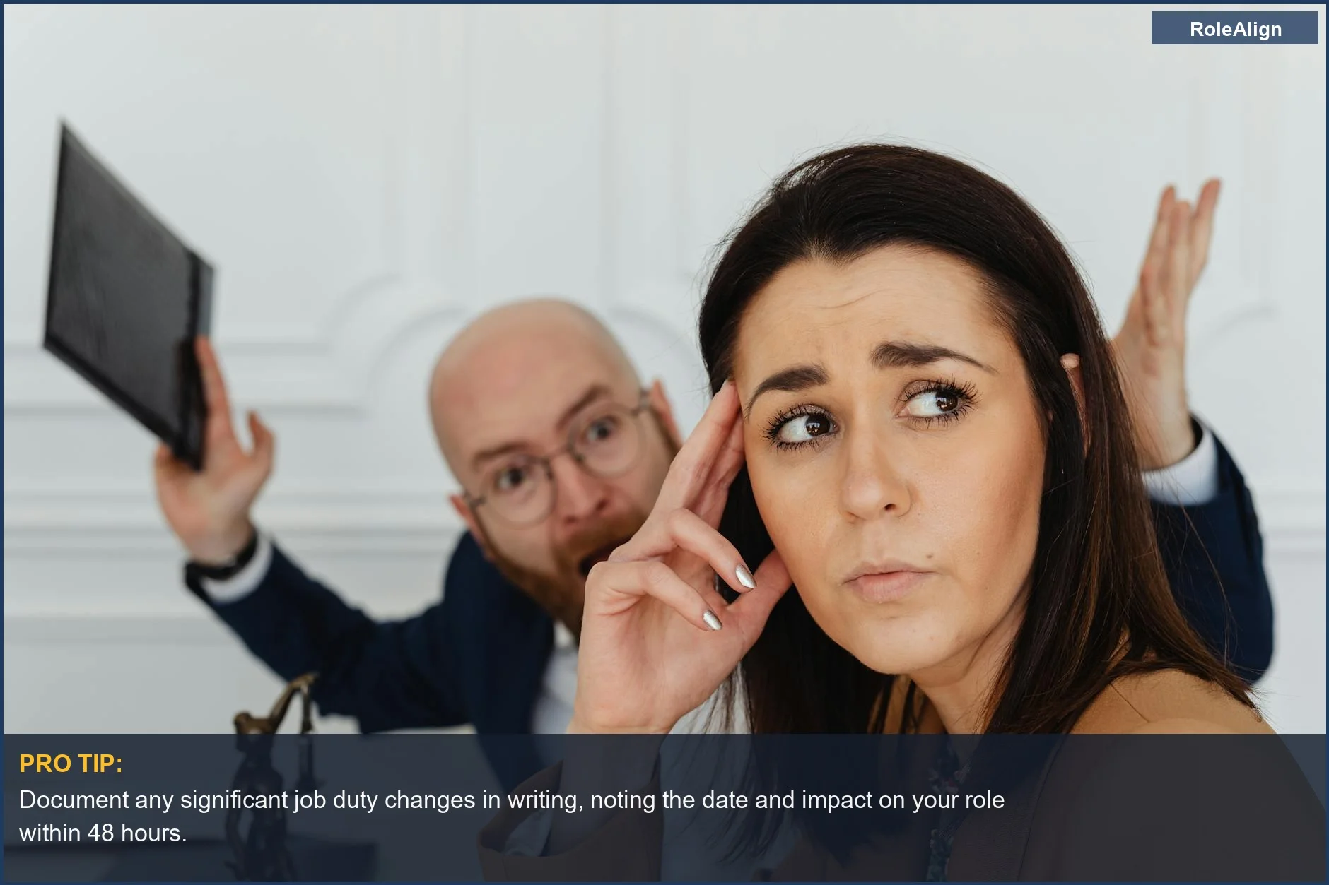 Frustrated colleagues in an office setting, highlighting the impact of a job description changed without consent.