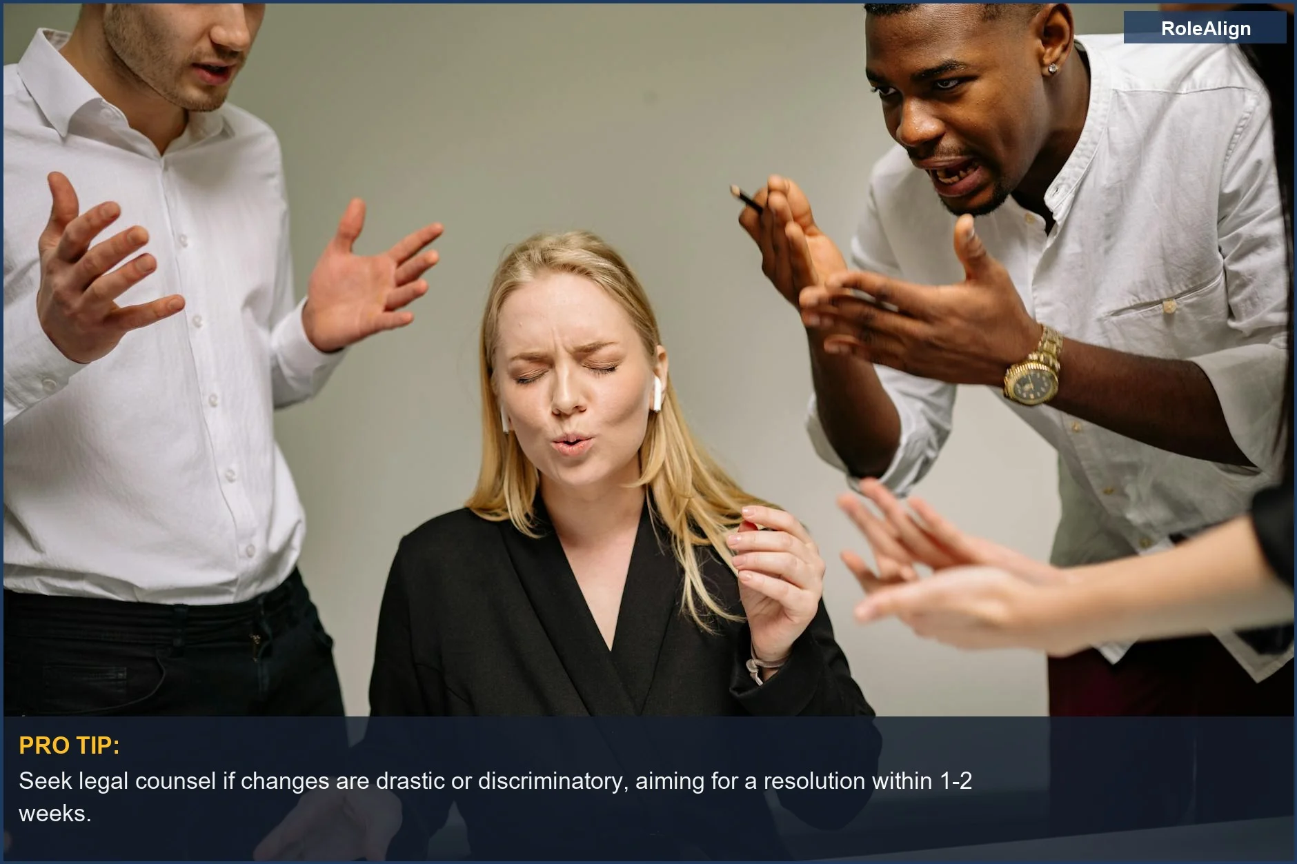 Stressed woman in a chaotic office, surrounded by arguing coworkers, reflecting the stress of a job description changed unexpectedly.