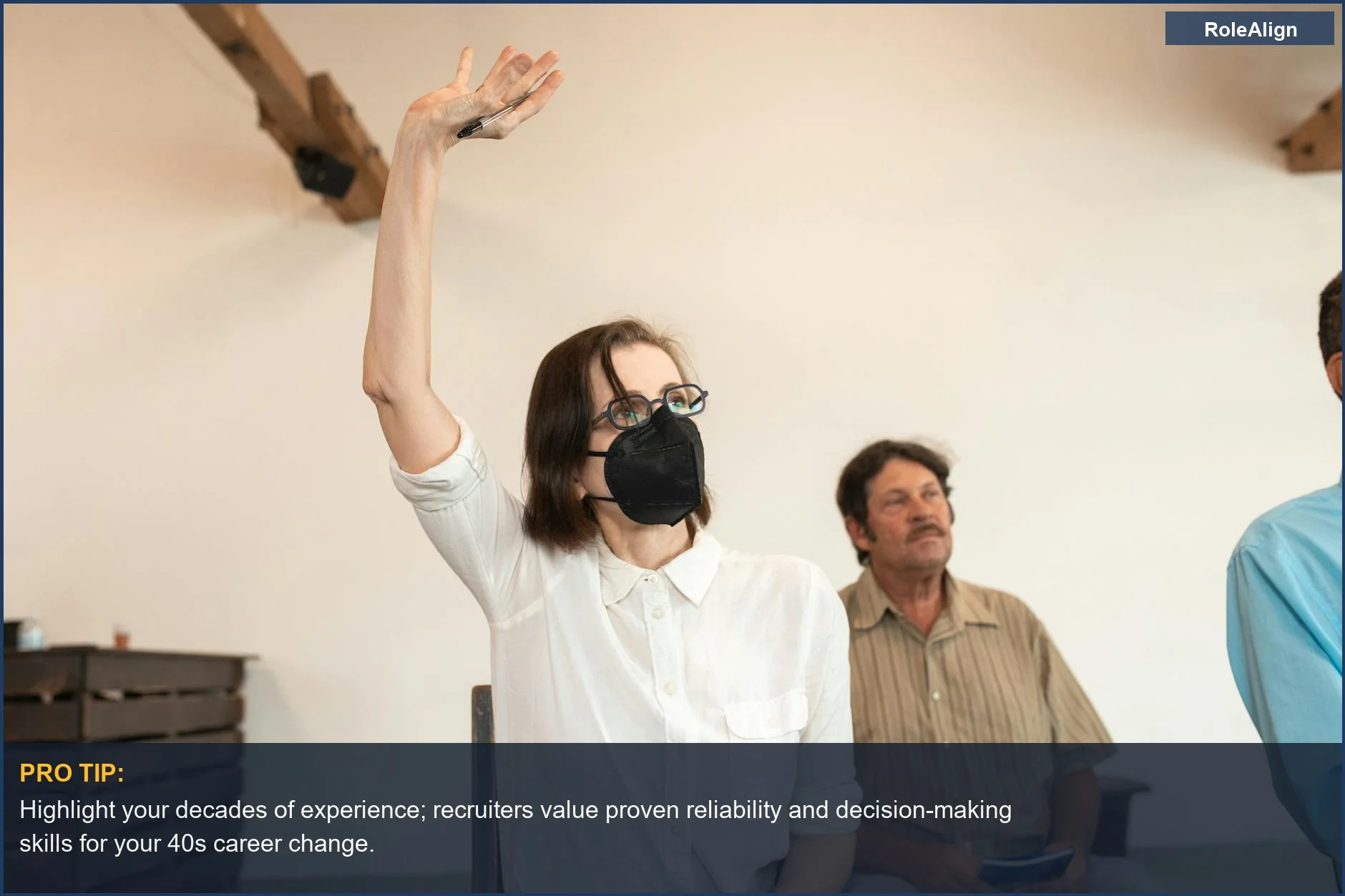 Woman in adult education class, wearing mask, embraces career change at 40 with new skills.