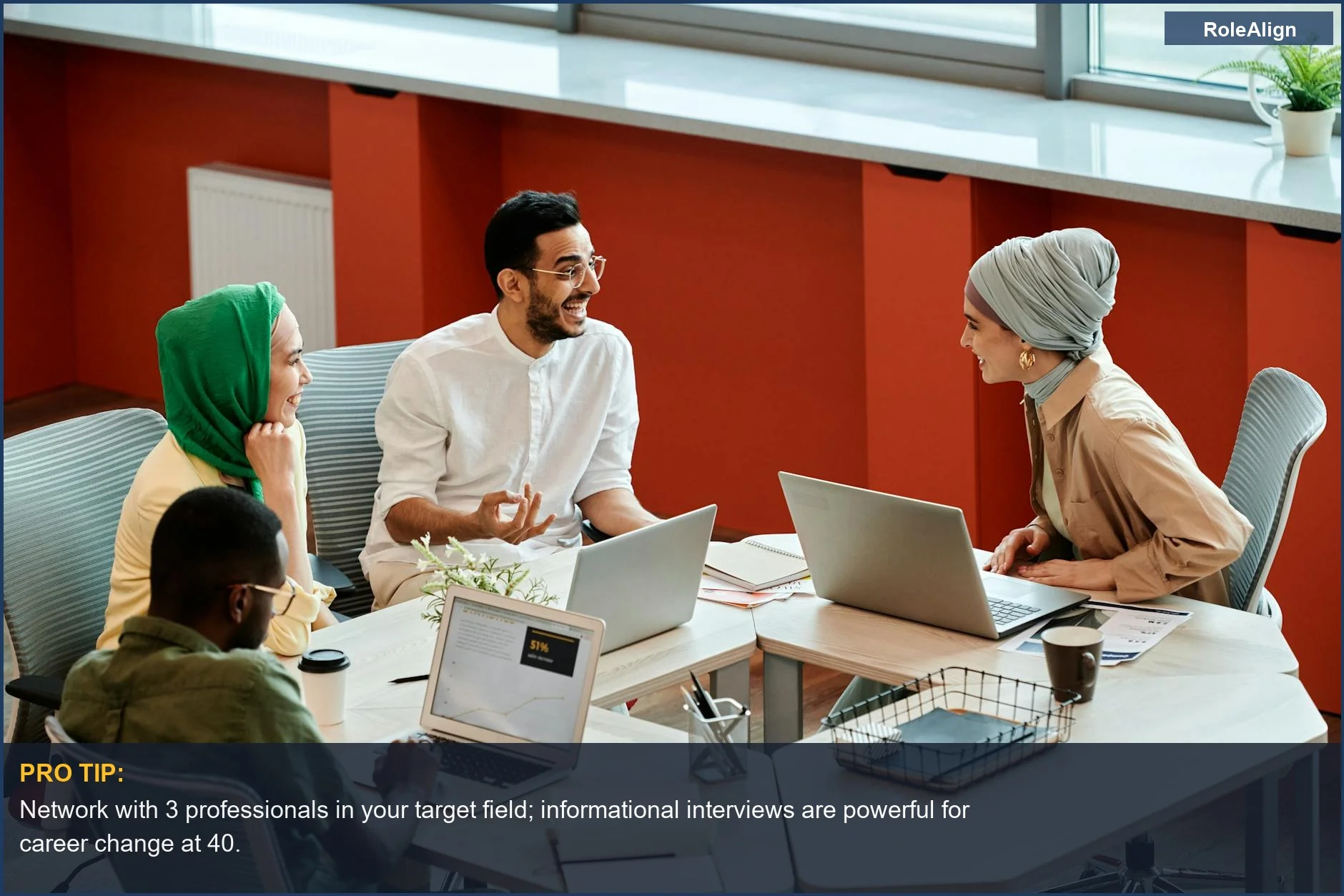 Diverse coworkers collaborate with laptops, representing networking for career change at 40.