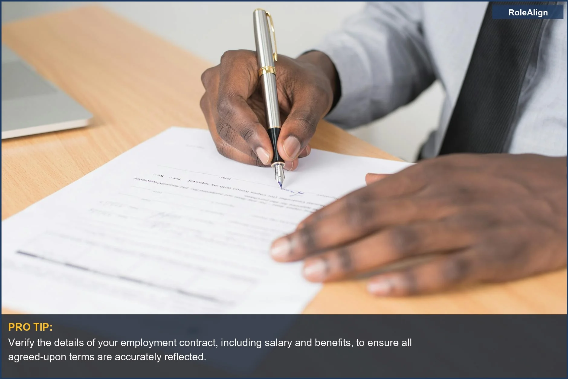 Businessman diligently signing a crucial employment contract at an office desk, signifying formal workplace agreements.