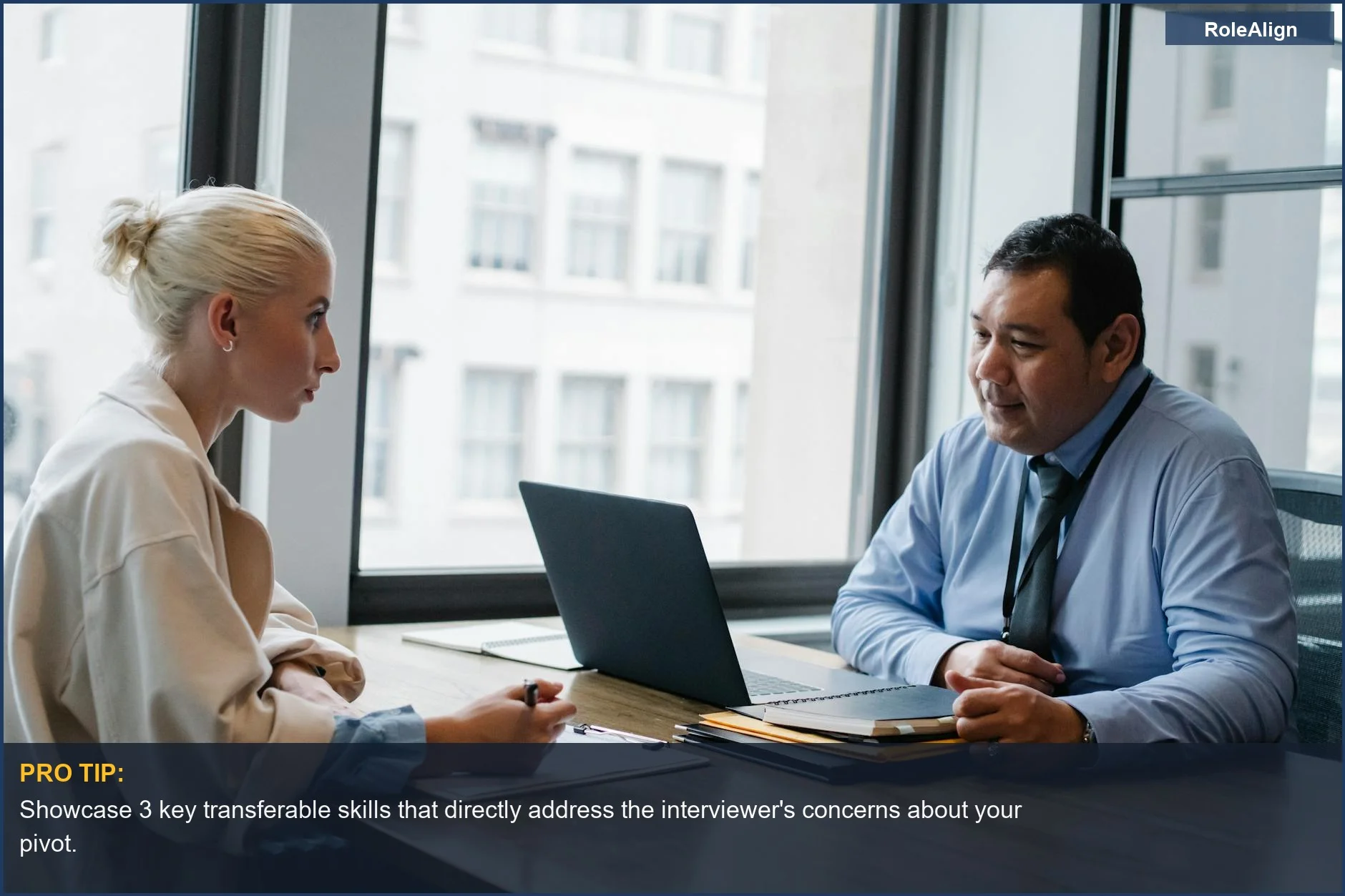 Two professionals discussing career pivot opportunities during a job interview in a modern office.
