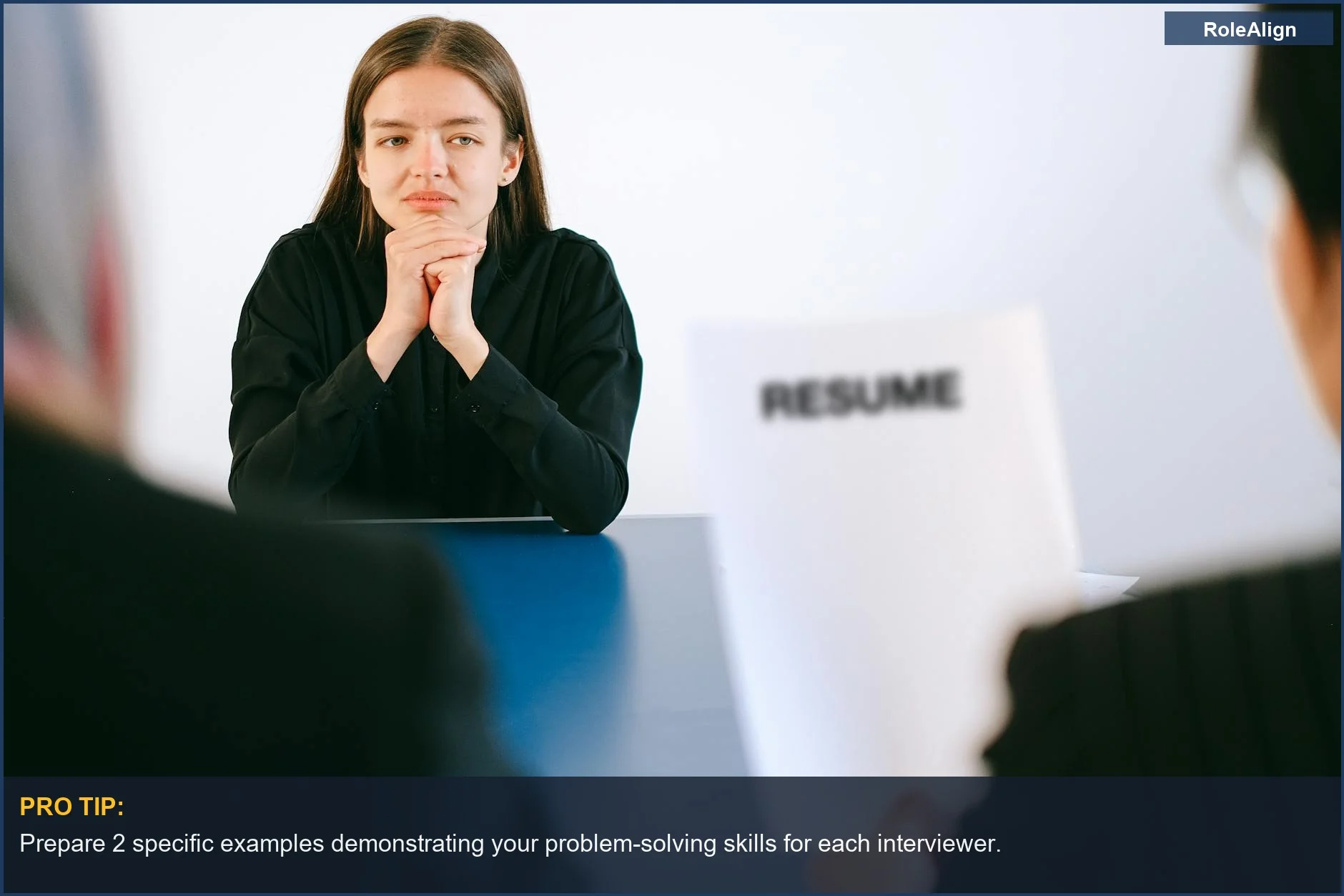 Woman in a job interview presenting her resume to two employers at a panel.