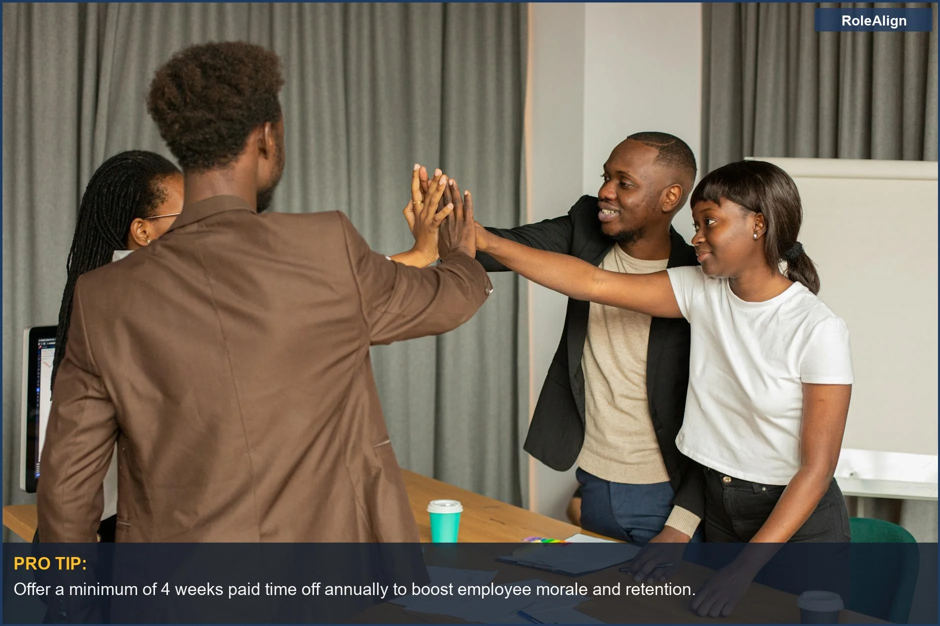 Group of diverse professionals high-fiving, reflecting positive outcomes from competitive employee compensation and benefits.