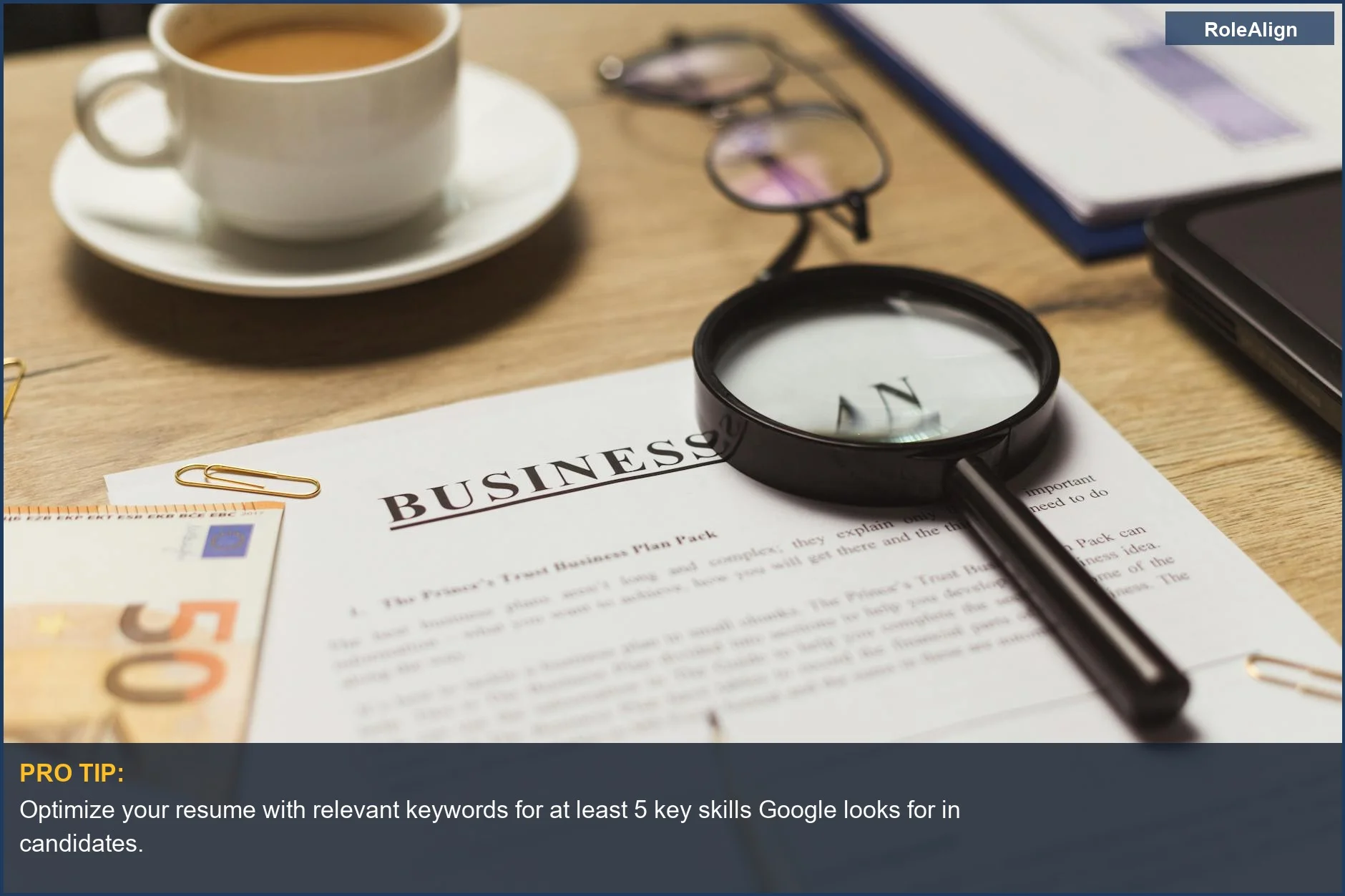 Business workspace with documents and coffee, illustrating the initial resume screening phase of the Google hiring process.