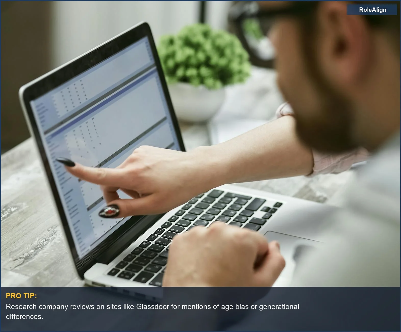 Analyzing data on a laptop, demonstrating the importance of spotting ageism hiring indicators in job descriptions.