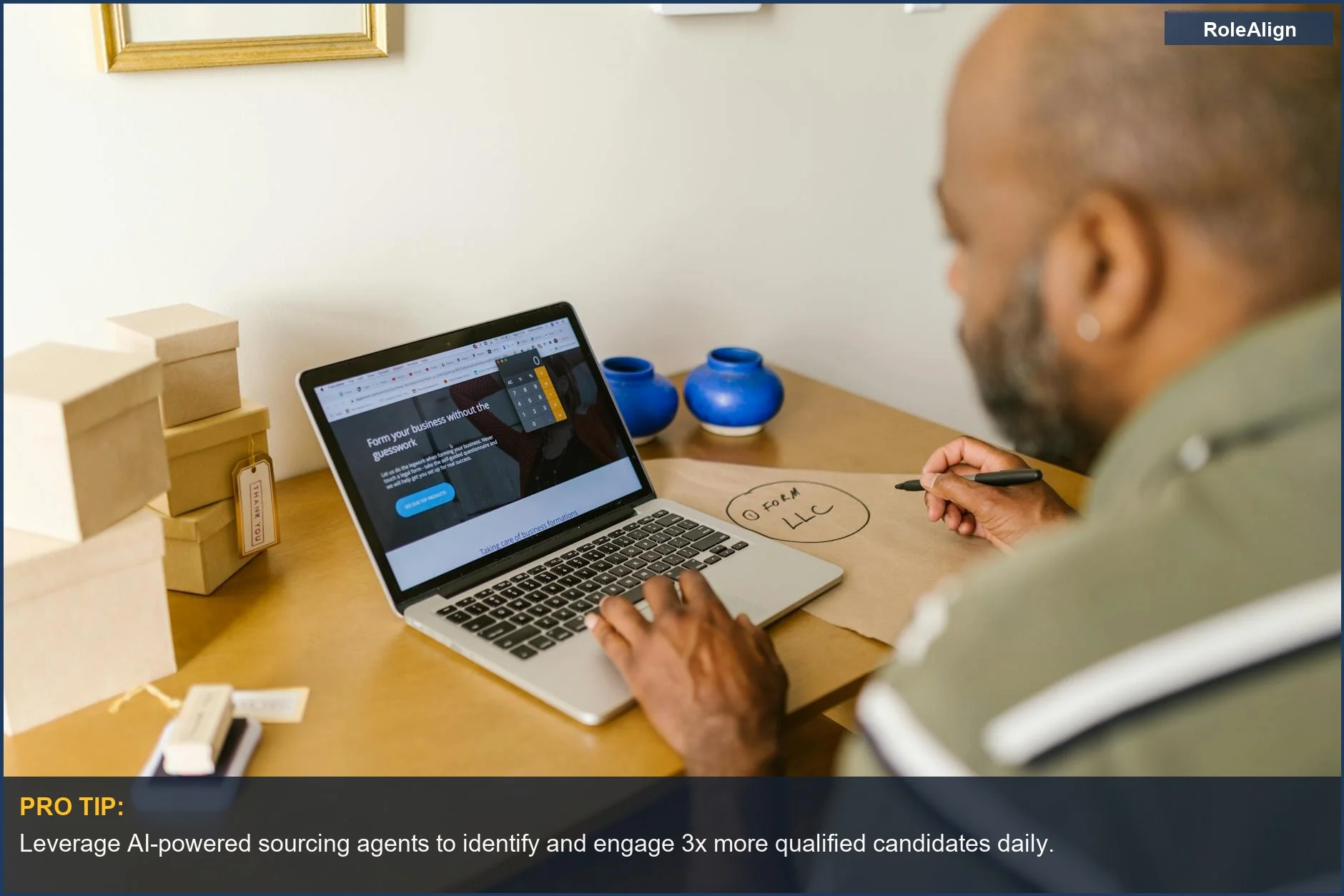 Entrepreneur planning business strategy on a laptop in a tech startup setting, showcasing AI in recruiting.