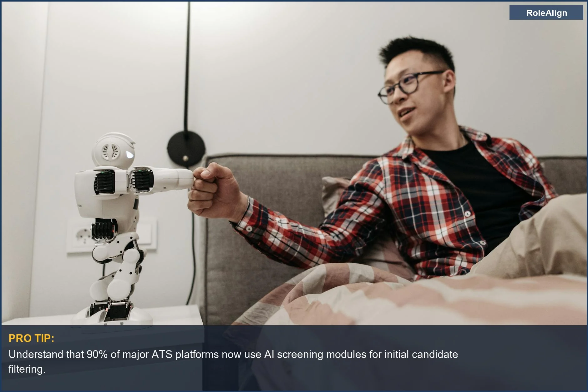 Asian man shaking hands with a robot, illustrating AI's role in modern job applications.