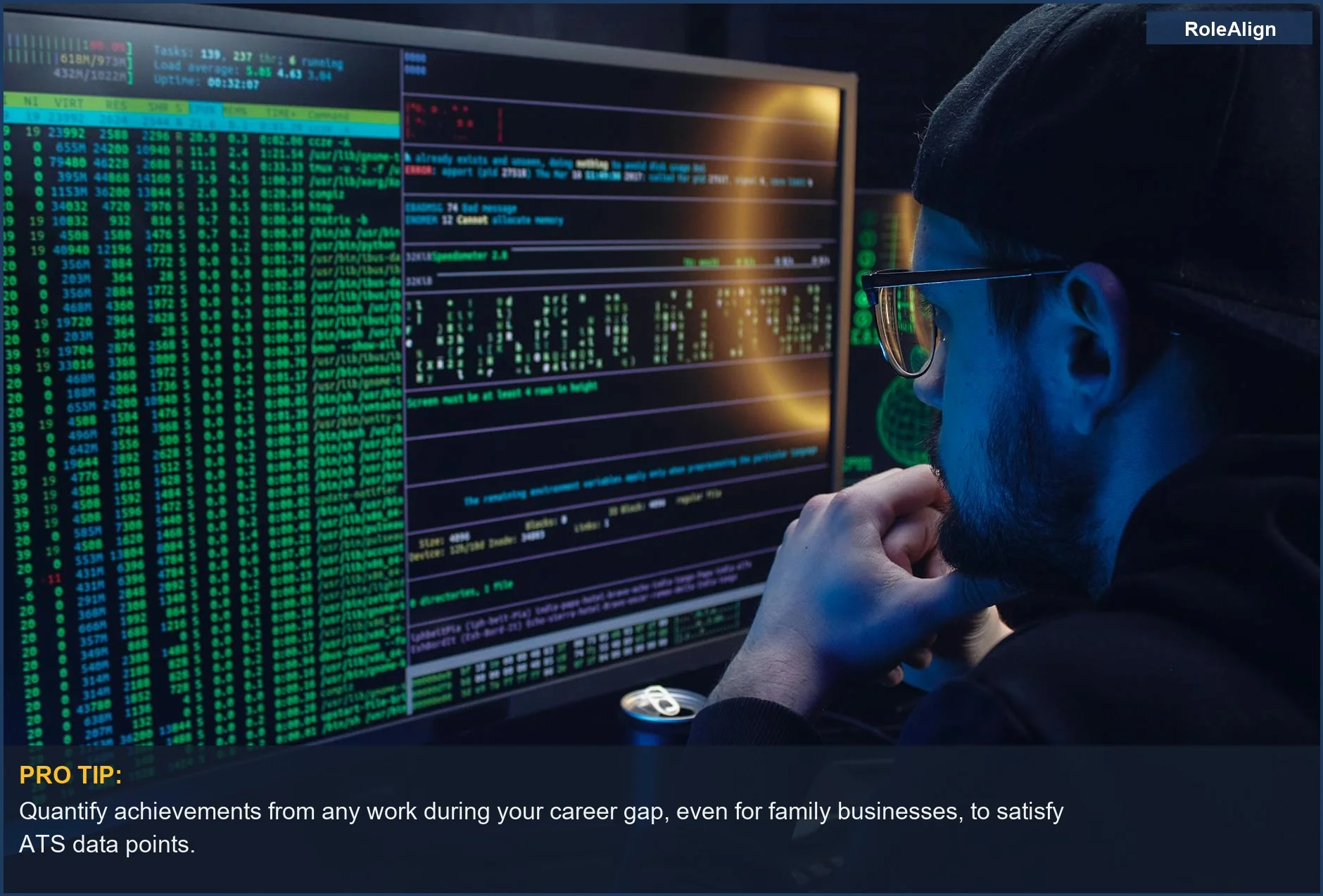 Man programming on dual monitors in a dimly lit room, relevant to ATS systems and understanding career gaps.