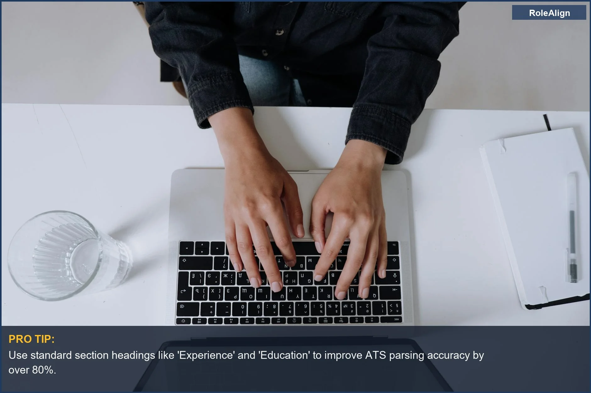 Overhead view of hands typing on a laptop, illustrating the technical processing behind ATS resume handling.