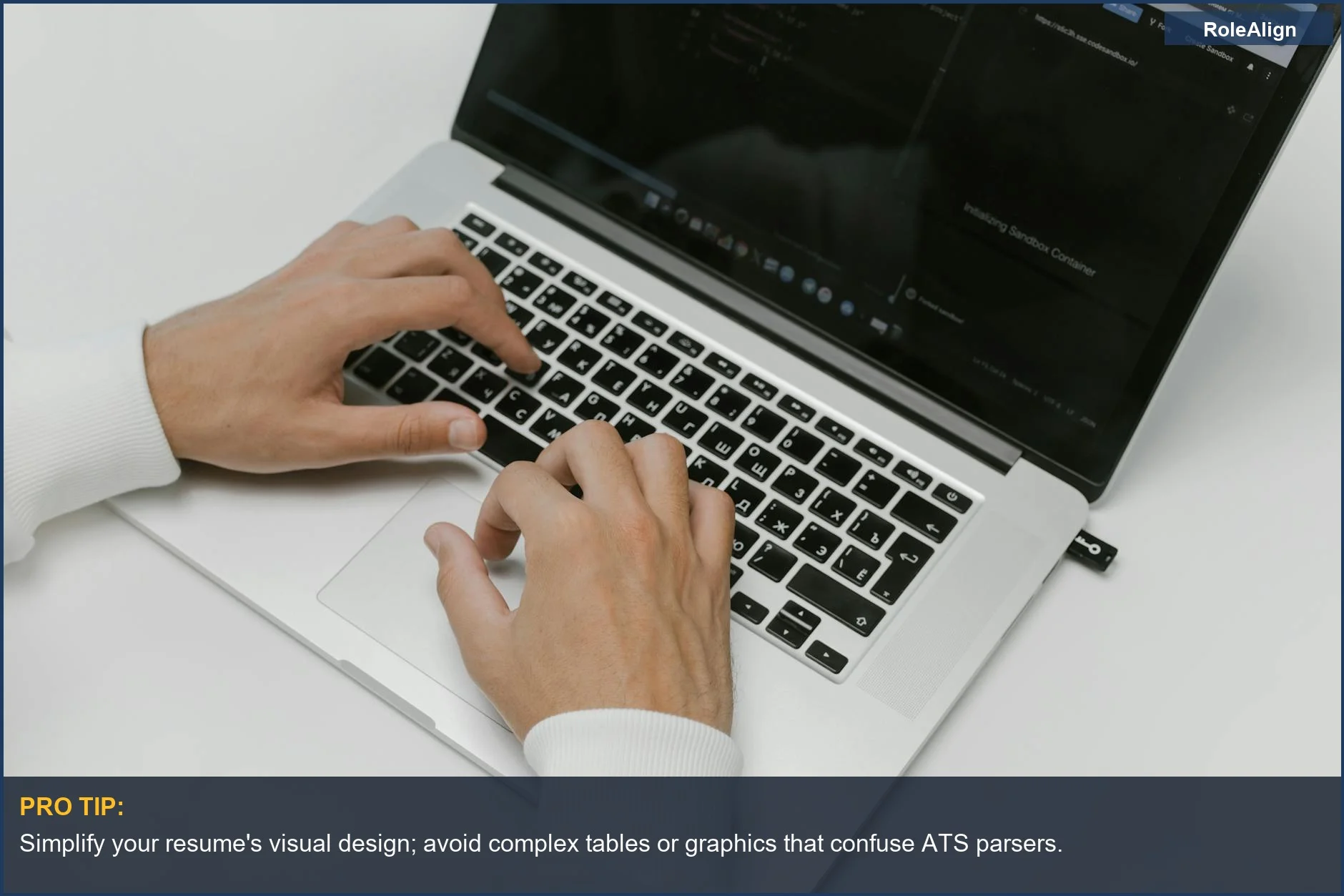 Hands typing on a laptop, highlighting the challenge of how ATS systems handle non-standard resume formats.