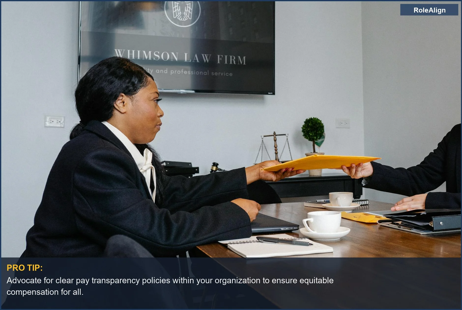 African American woman shares documents, illustrating how companies exploit pay transparency loopholes.