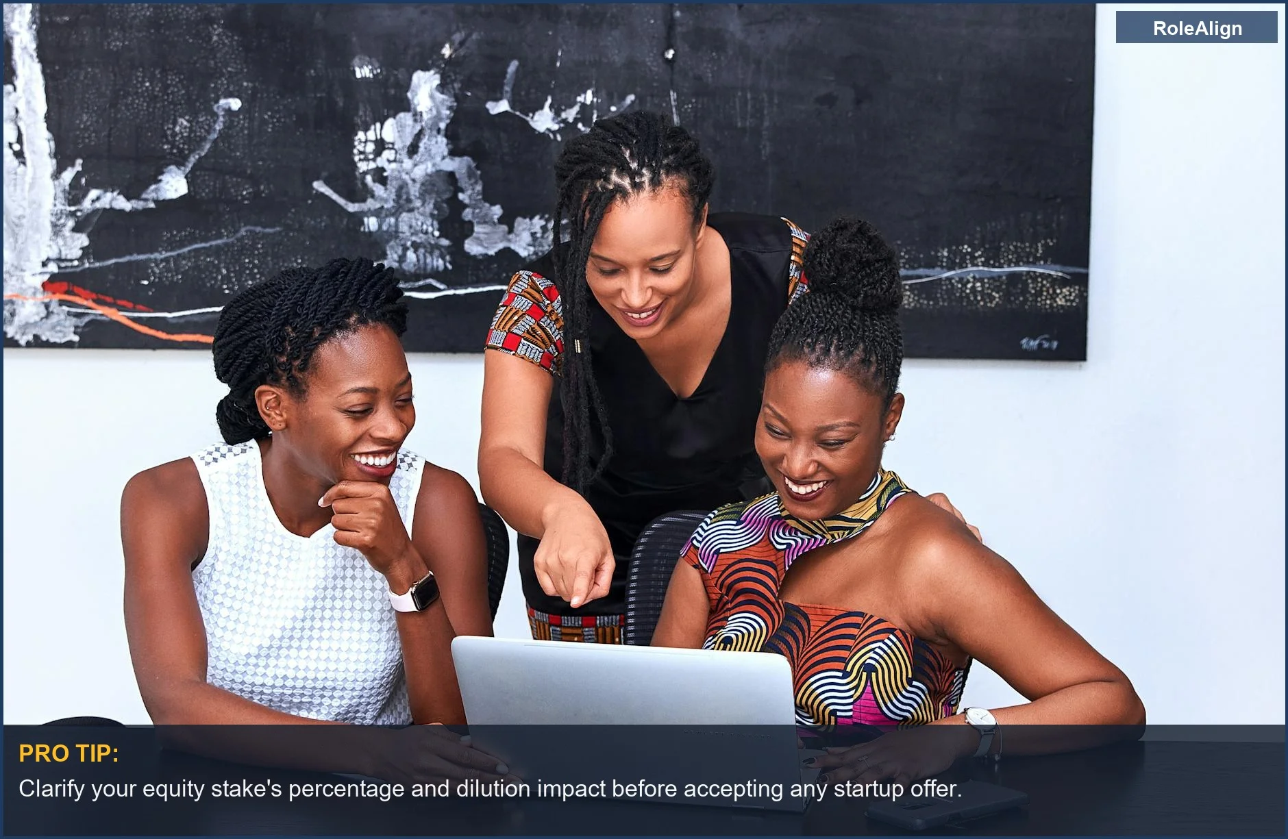 Diverse team of women collaborating on a laptop, highlighting the importance of understanding startup equity basics.