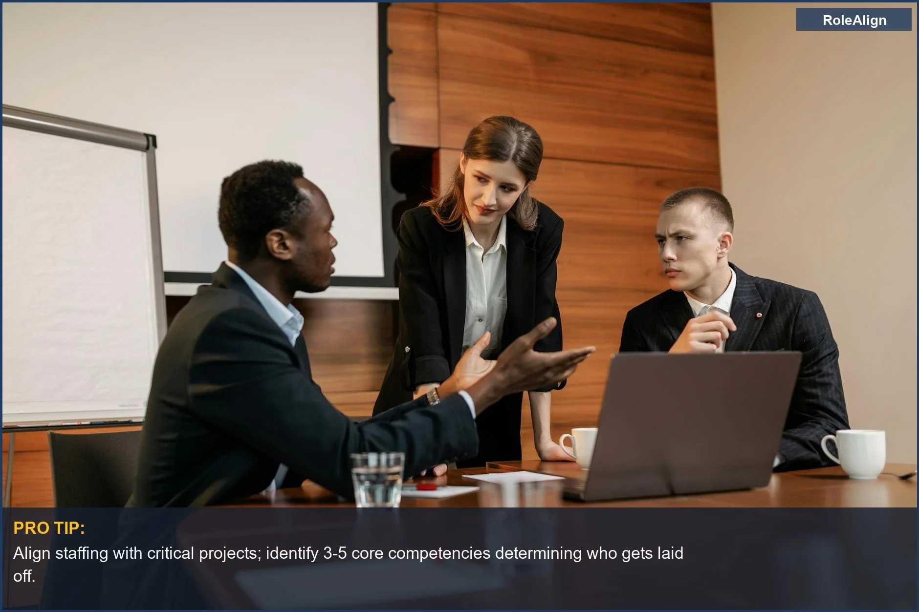 Three colleagues seriously discuss project roadmaps, illustrating who gets laid off based on critical skills.