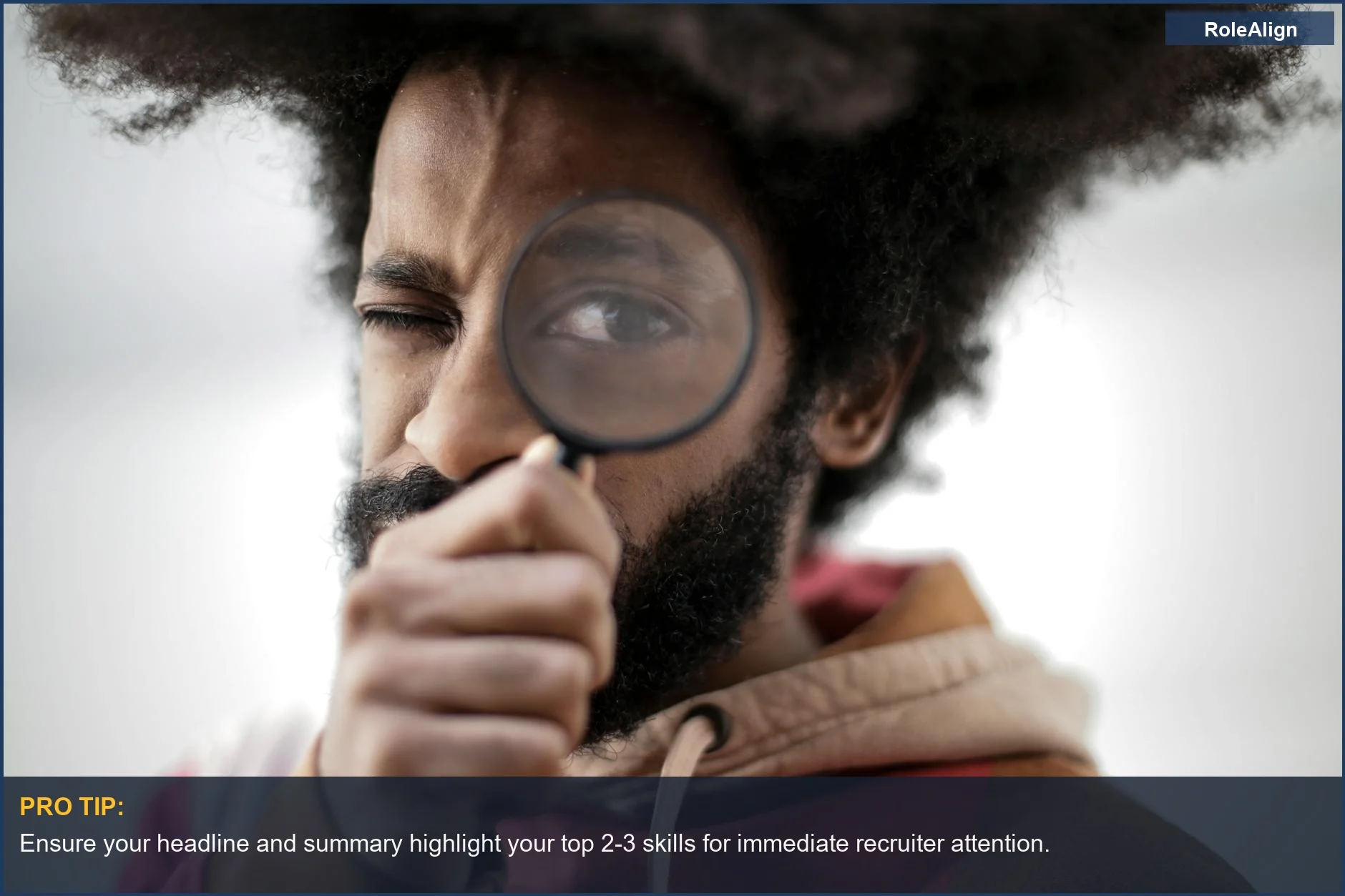 Man with afro hair inspecting with a magnifying glass, showing what recruiters look at on LinkedIn.