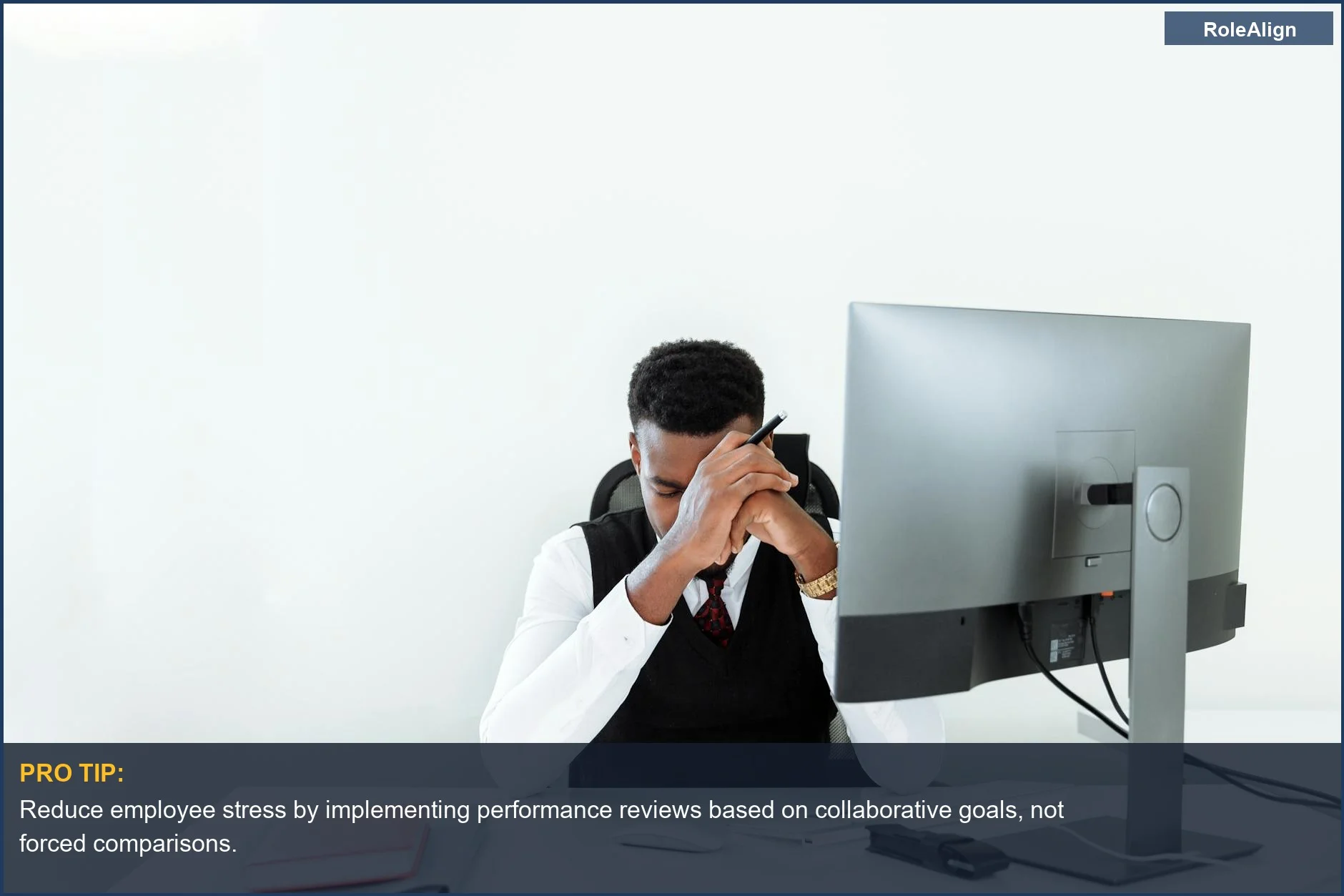 Stressed businessman working late, highlighting the negative impact of stack ranking employees on individual well-being.