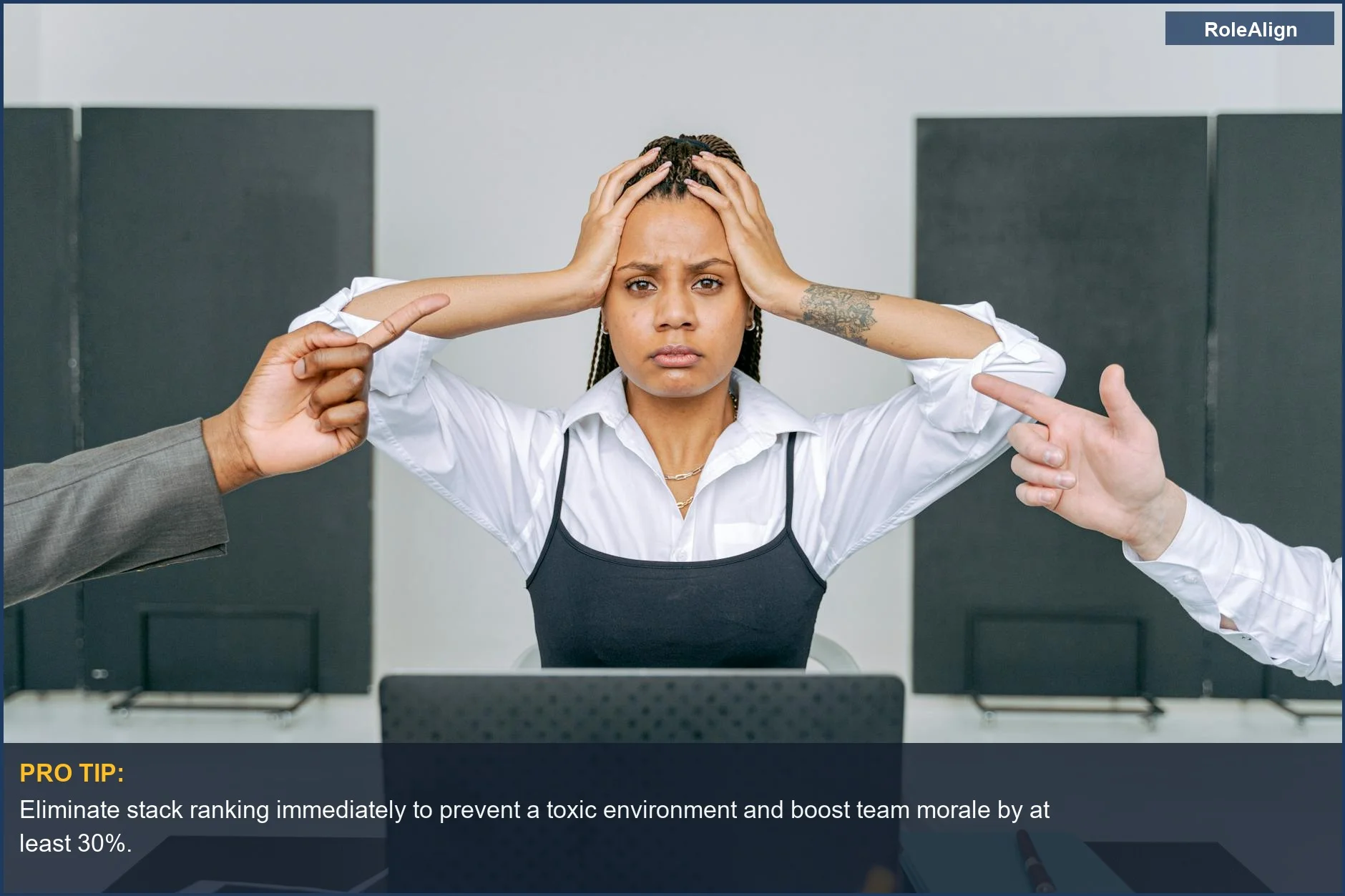 Woman feeling blamed in office, showing workplace conflict and the problems of stack ranking.