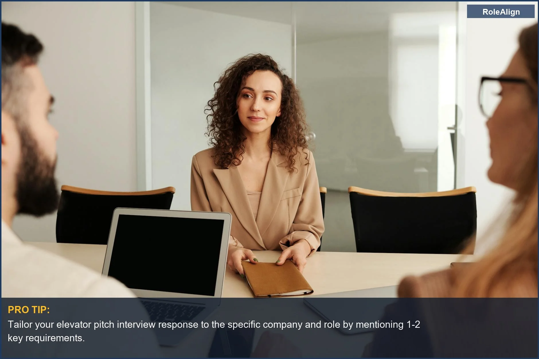 Woman in business suit confidently participating in a job interview, showcasing professional elevator pitch skills.