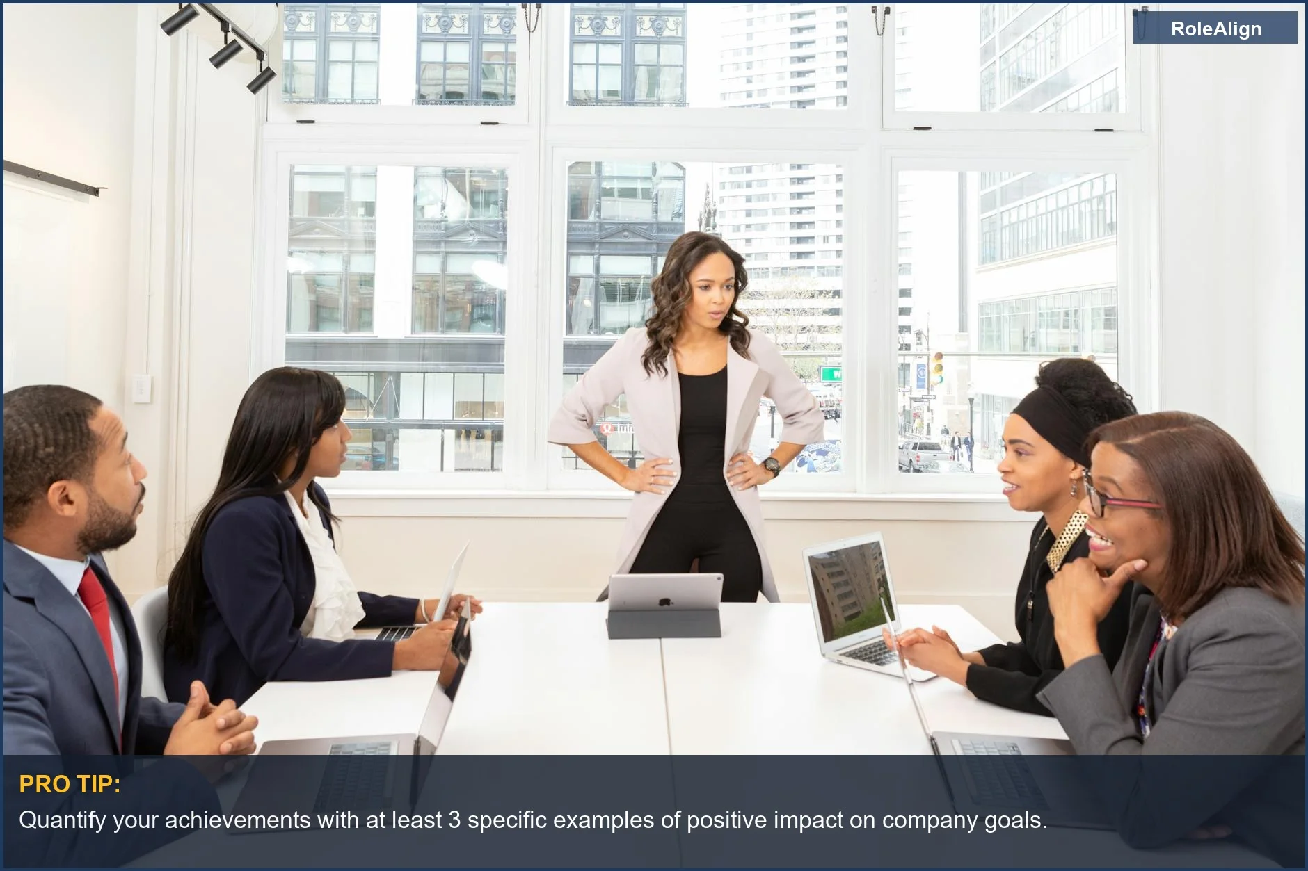 Diverse professionals in a modern office discuss strategy, highlighting the importance of demonstrating value to ask for a raise.