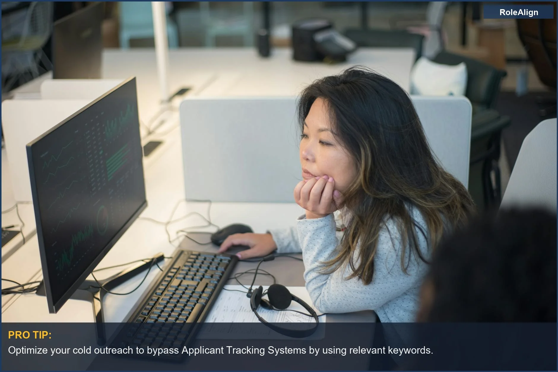 Woman intently viewing computer screen in modern office, highlighting ATS system importance.