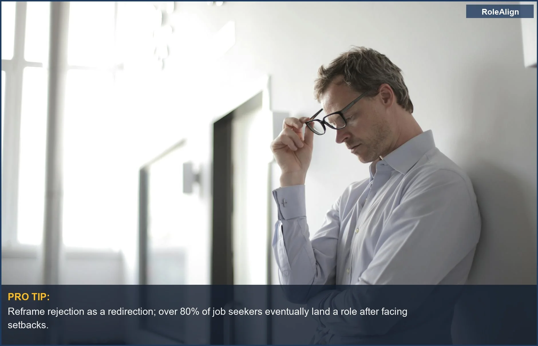 Thoughtful man in glasses contemplating job rejection, a common hurdle in the job search.