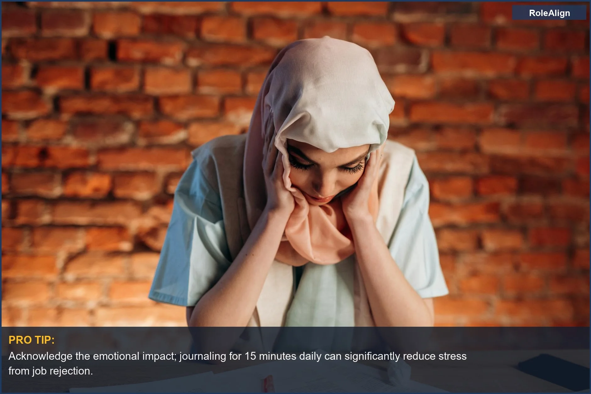 Focused woman in hijab studying, showing concentration for handling job rejection effectively.