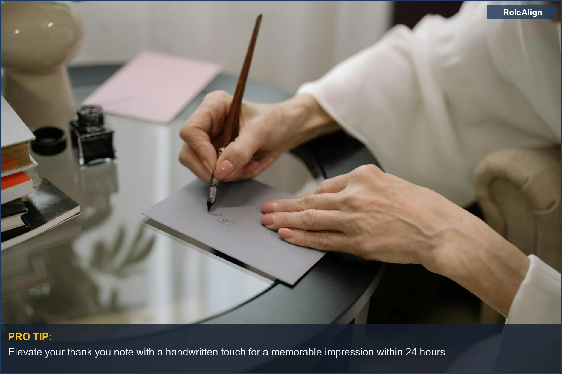 Elegant hands writing with a fountain pen on a gray envelope, symbolizing professional follow up after an interview.