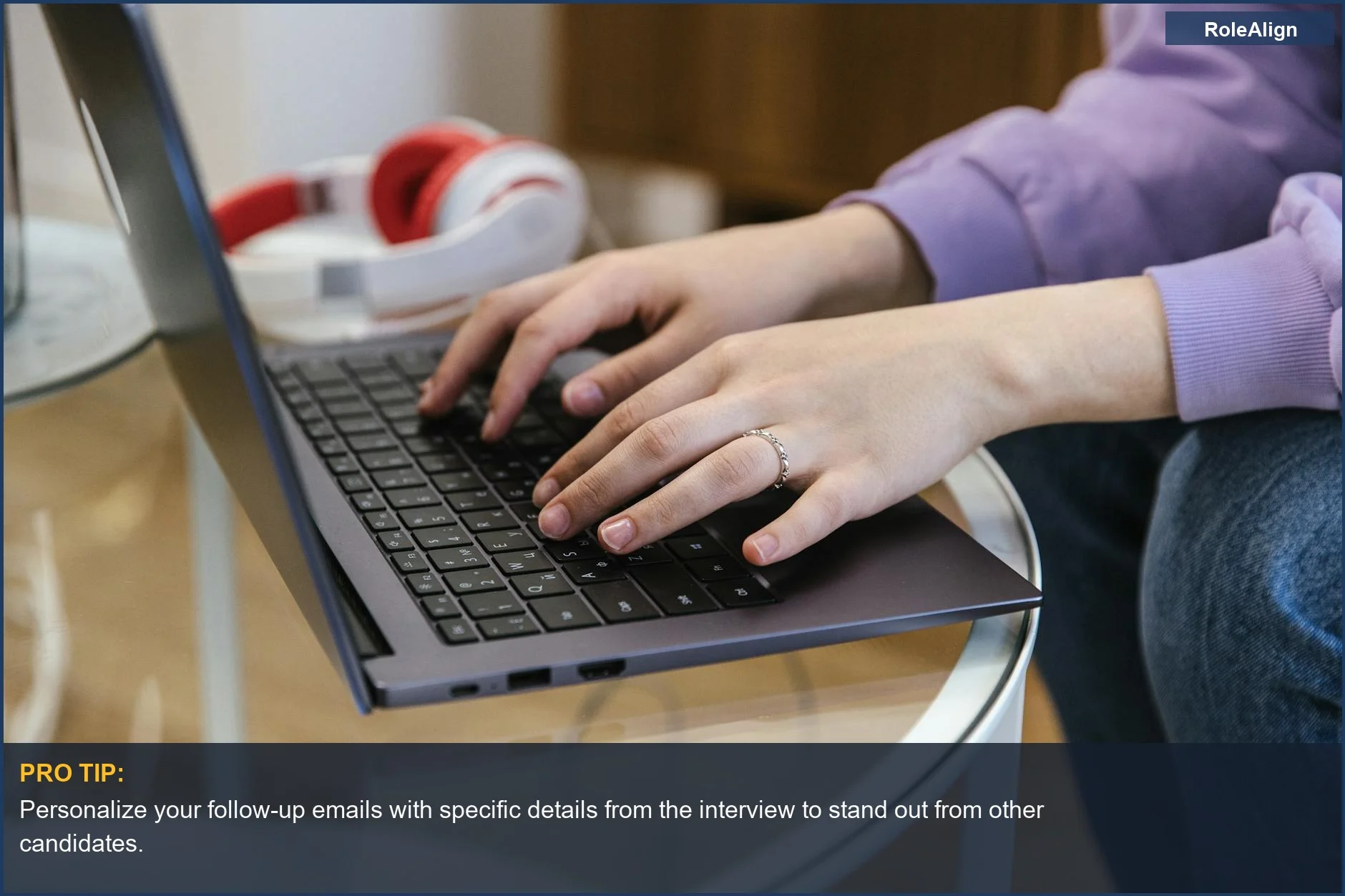 Close-up of hands typing on a laptop, highlighting the how to follow up after interview email process.