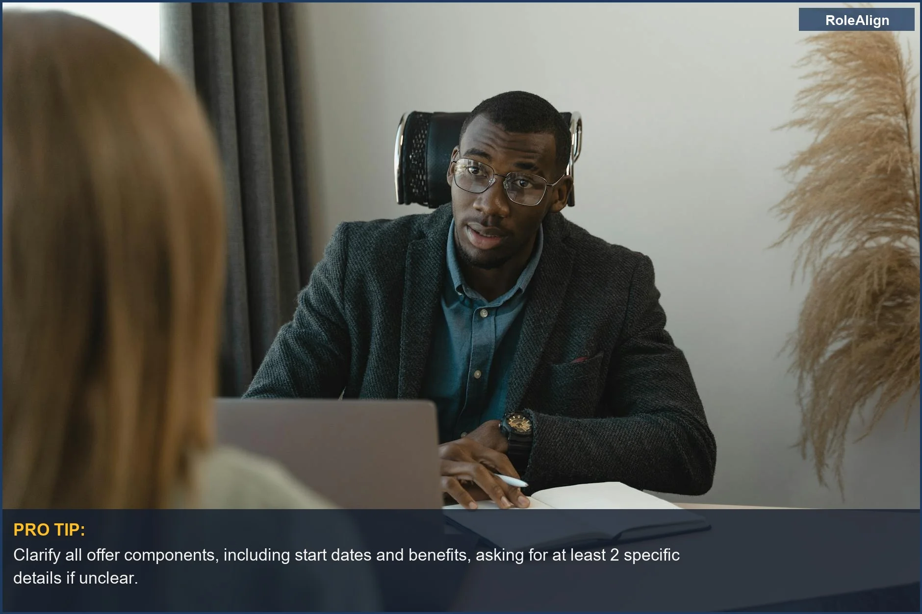 Formal interview setting where a businessman presents a job offer to a candidate.