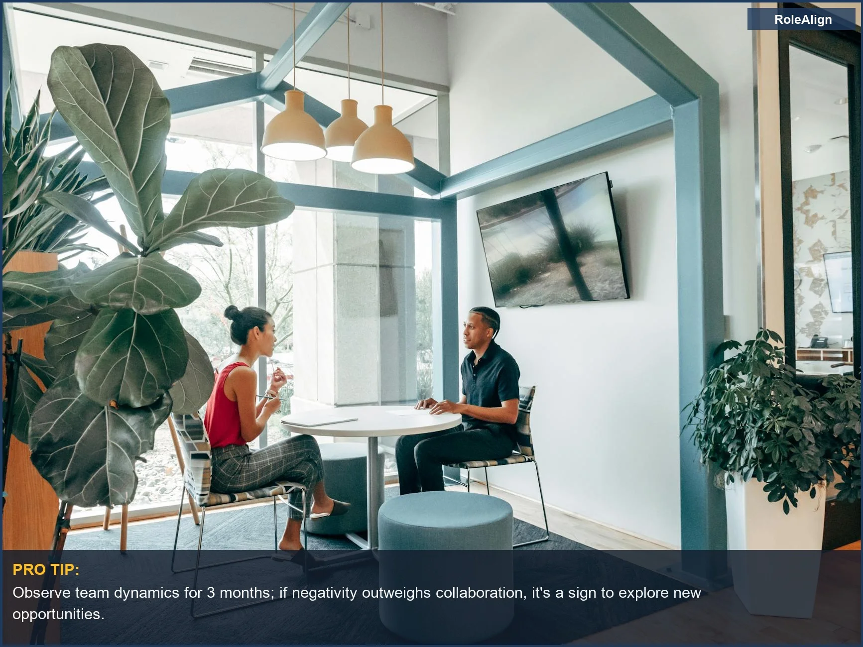 Colleagues collaborating in a modern office, illustrating the importance of a positive work environment when considering when to quit your job.