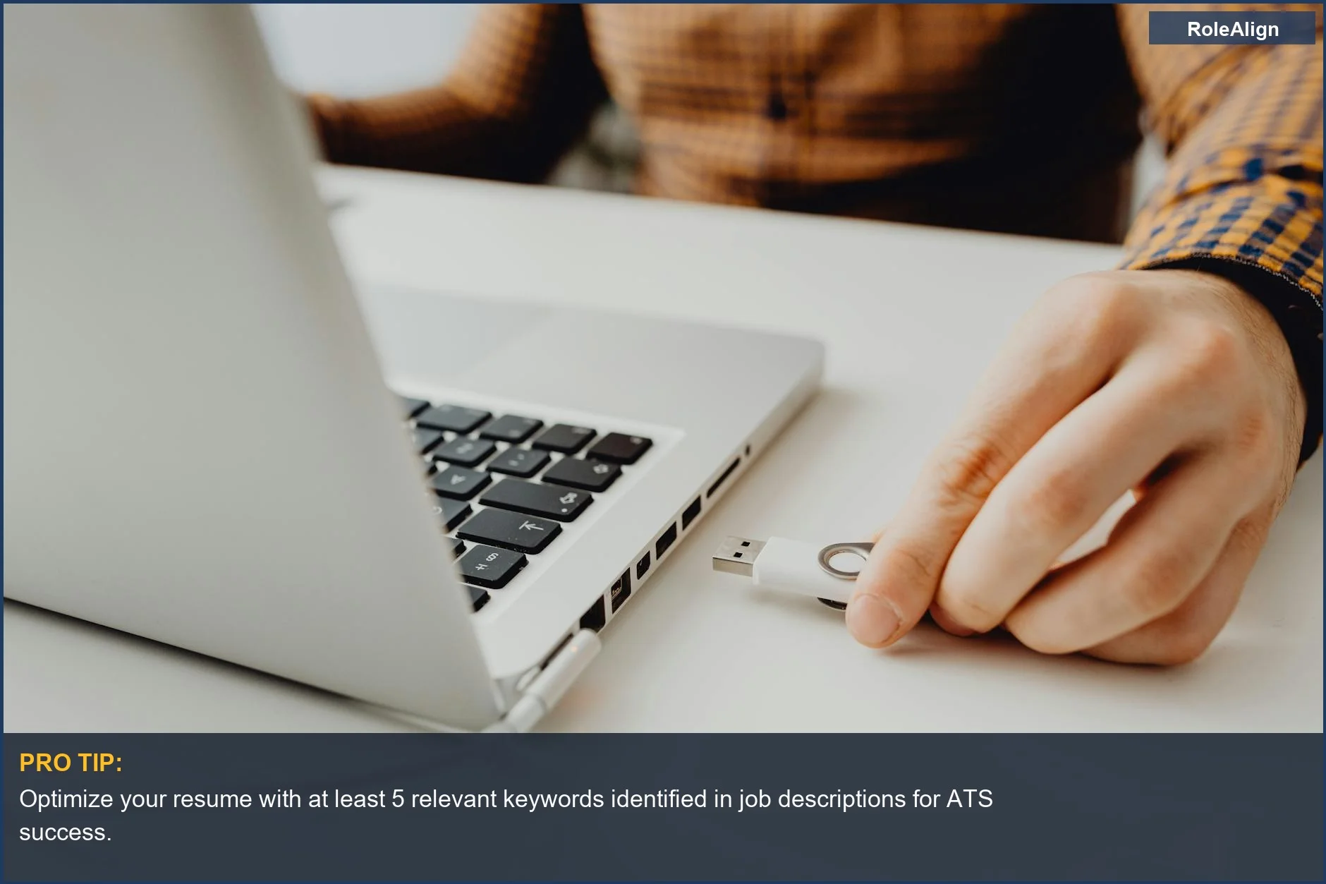 Person plugging USB into laptop, symbolizing data connection and the importance of keywords for career changes.