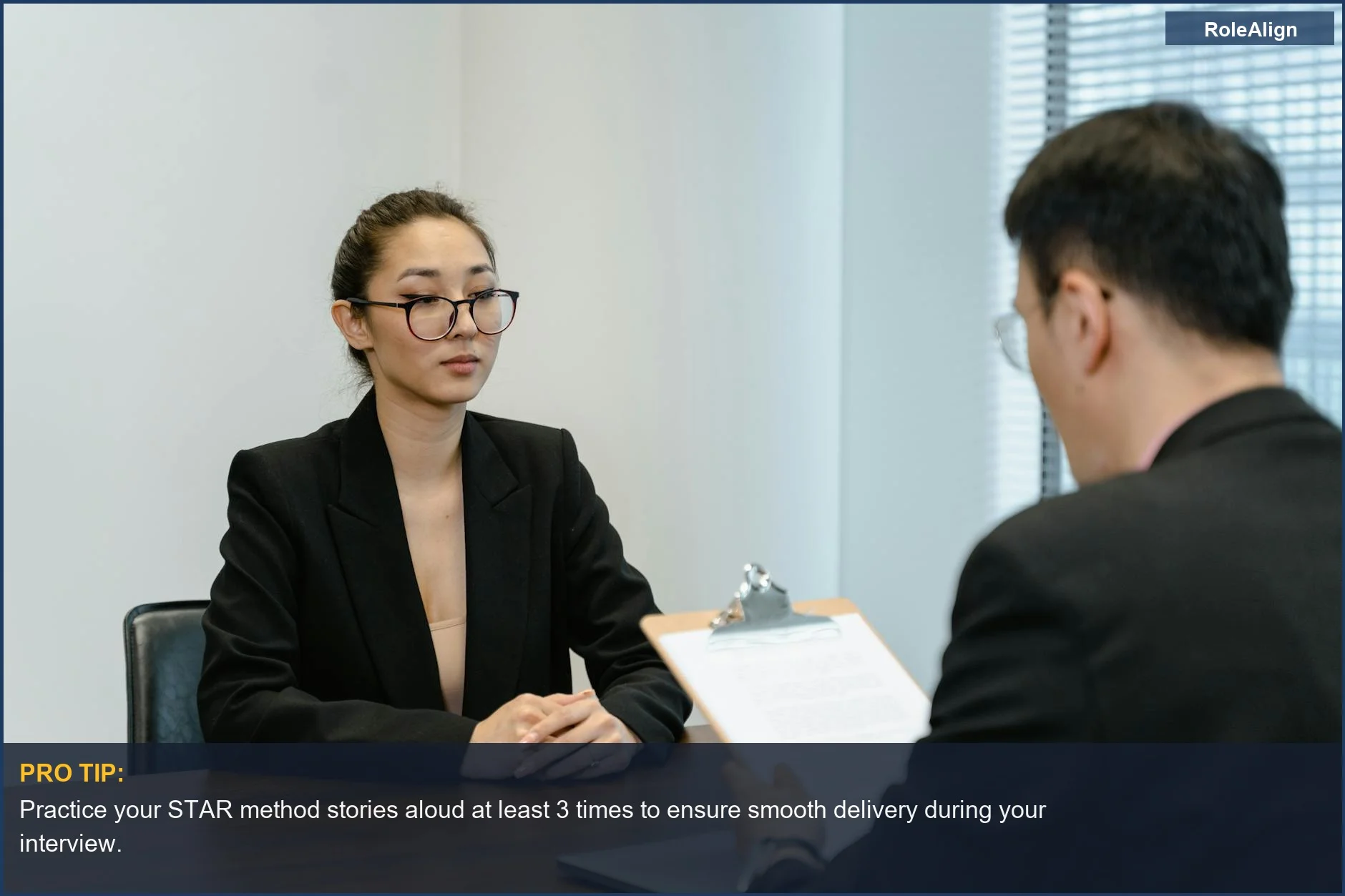 Professionals in a modern office conducting a business interview, highlighting the importance of behavioral interview preparation.