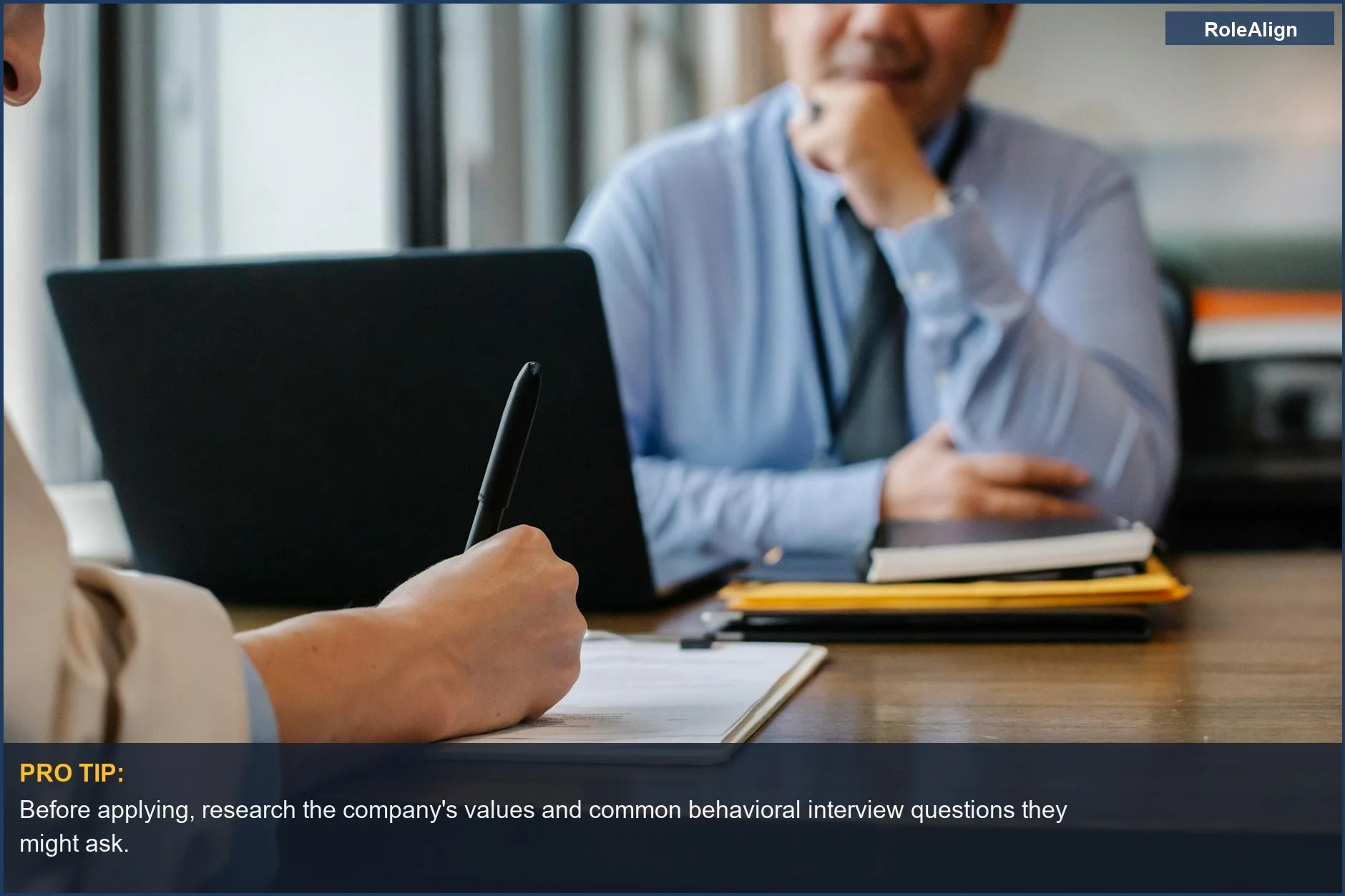 Anonymous female applicant filling out a questionnaire in an employer's office, a step in behavioral interview prep.
