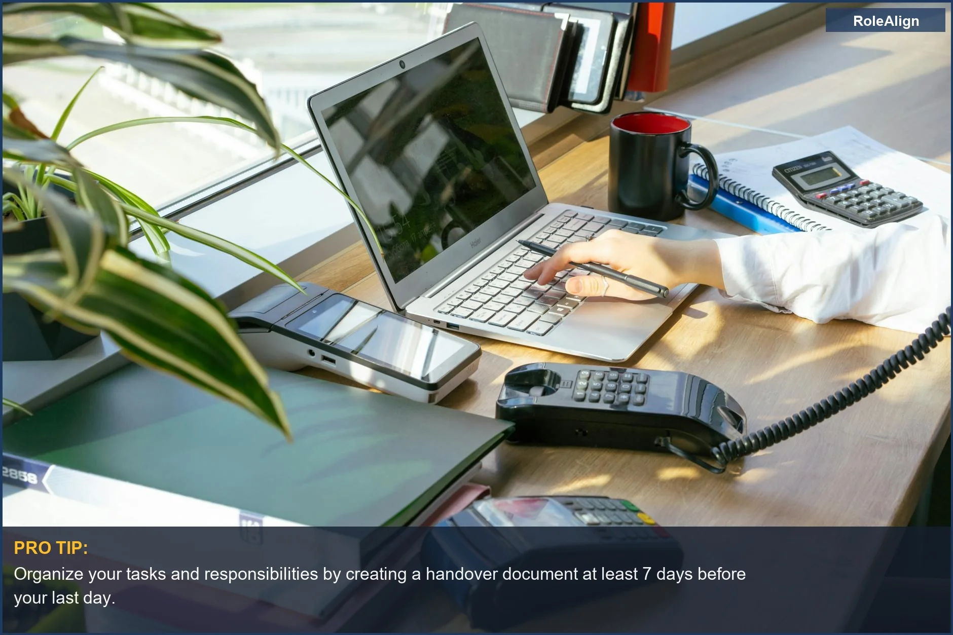 Bright, modern office desk with plants and electronics, representing a productive environment for planning your resignation.