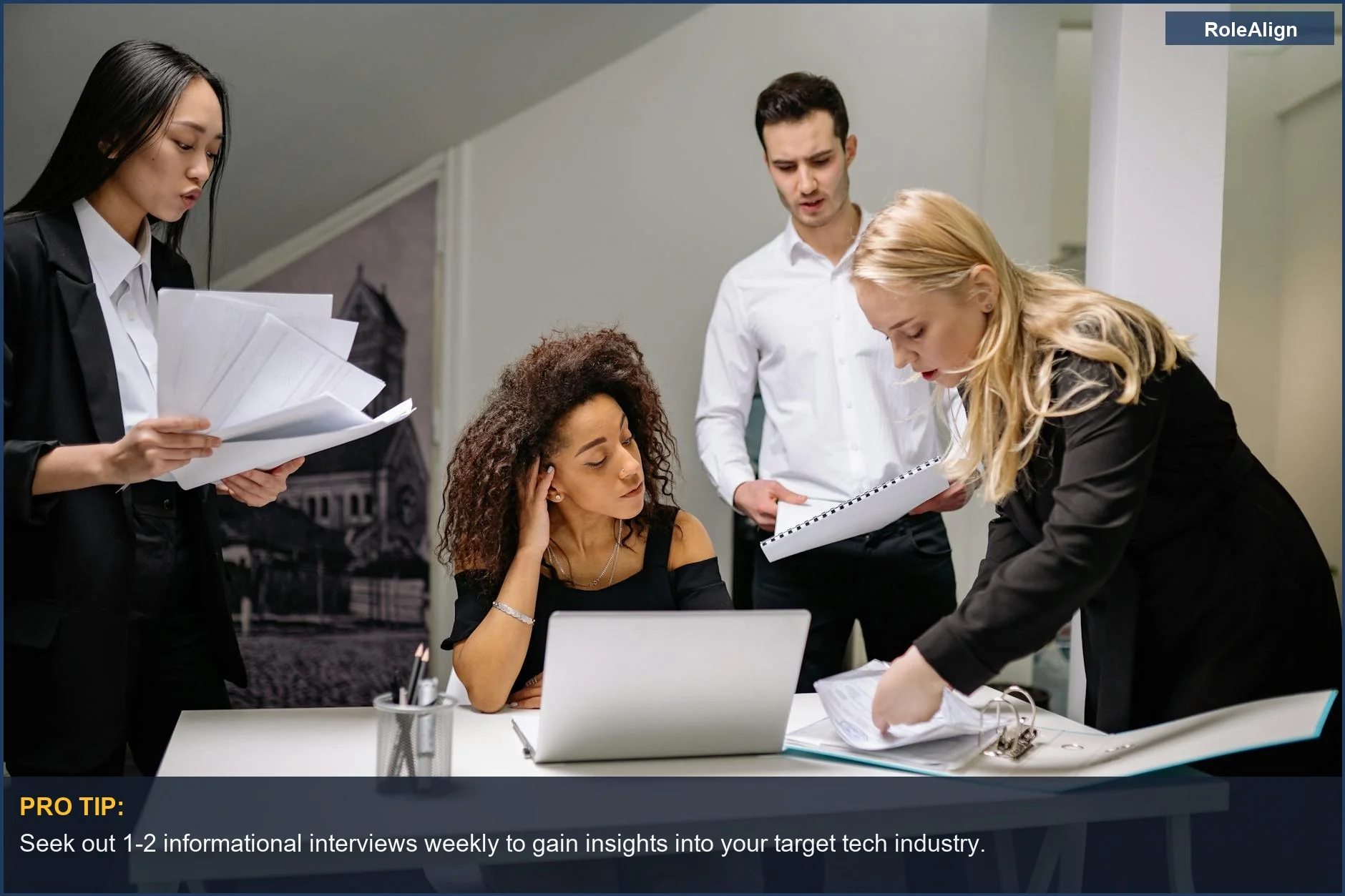 Coworkers brainstorm ideas over paperwork and laptops in a corporate office, a common scene for career changers.