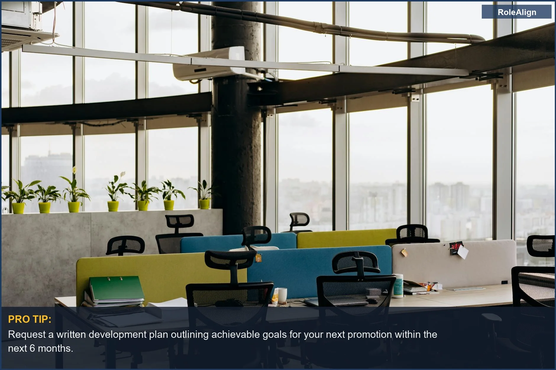 Open office with colorful dividers and city view, showing how to identify if your company is stringing you along with false career promises.