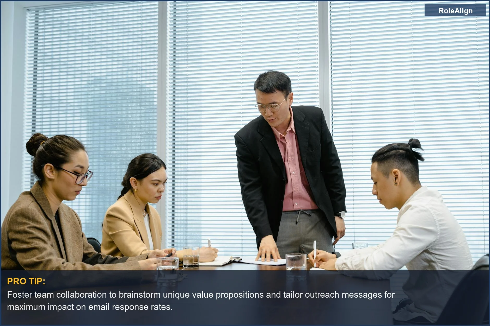 Diverse professionals collaborating during a meeting, discussing strategies for improving email response rates in business.