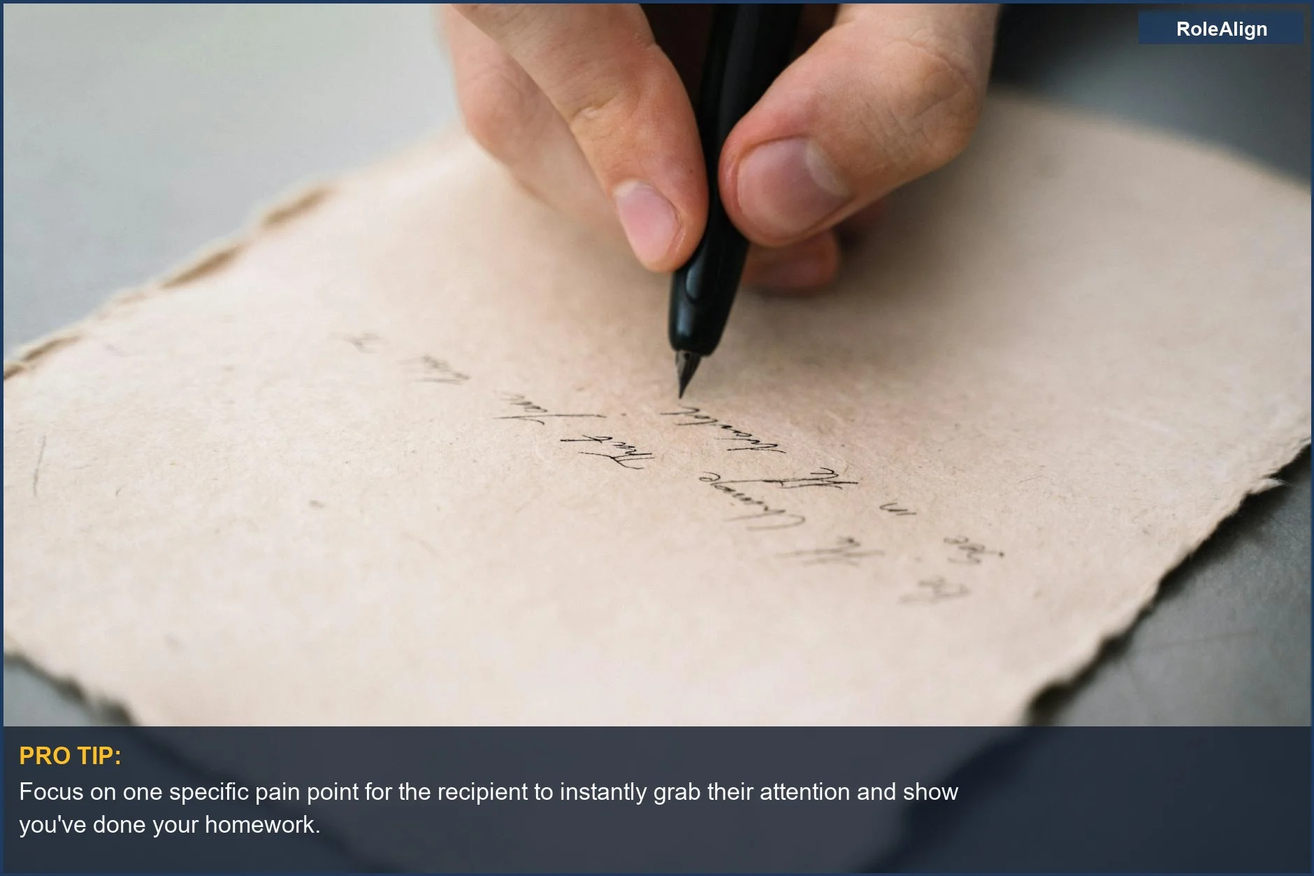 Person's hand meticulously writing a cold email with a black pen on textured paper for effective cold outreach.