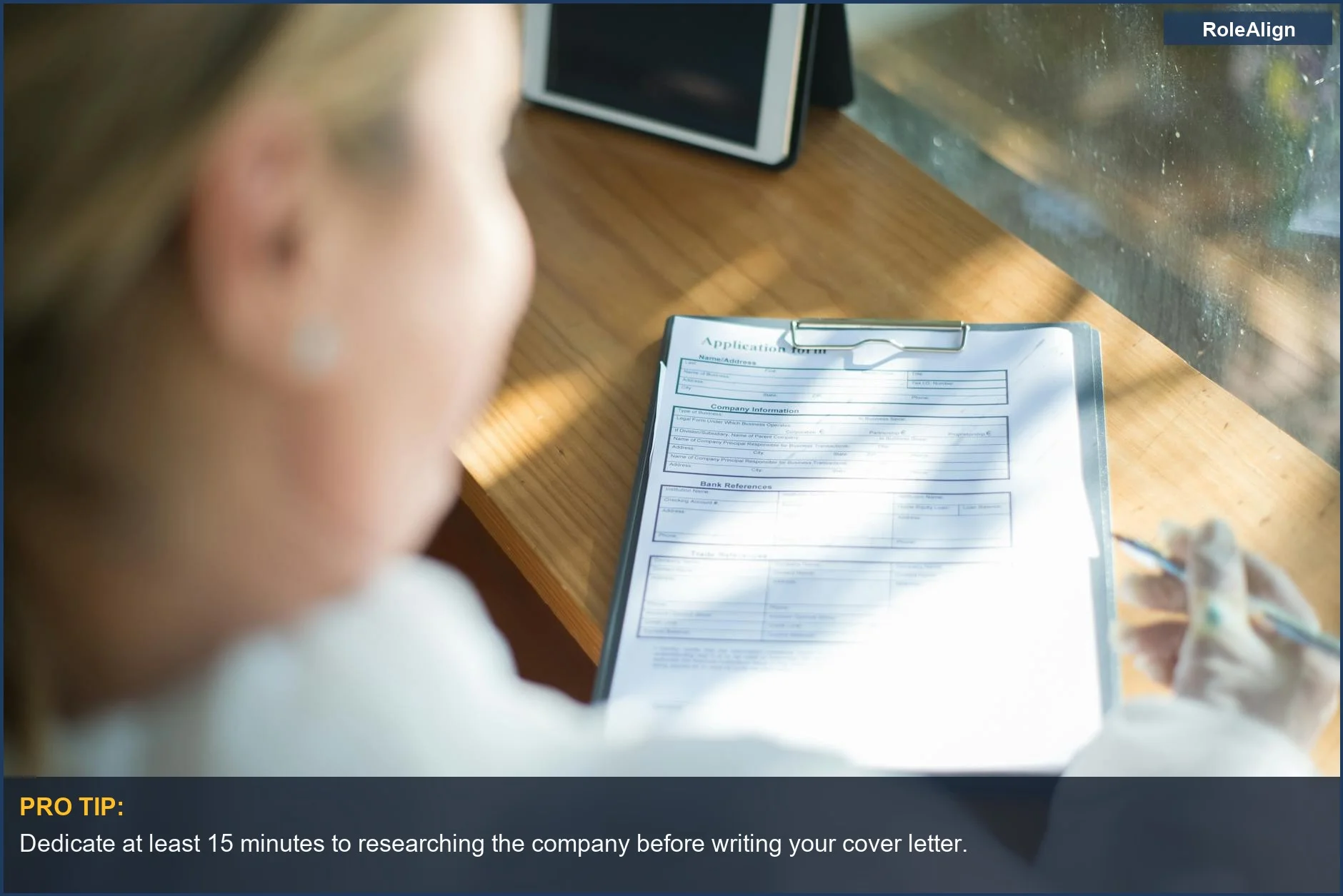 Woman filling out application form, a visual for how to write a cover letter that gets noticed.
