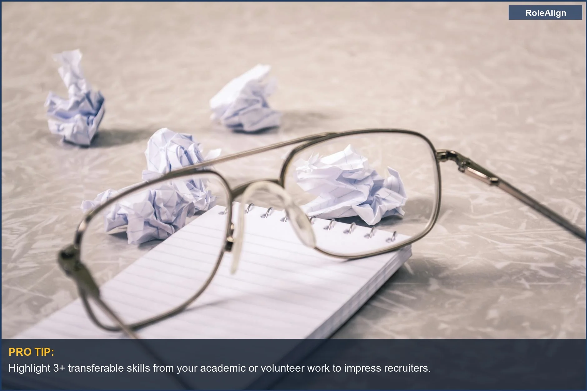 Brainstorming resume ideas with crumpled paper and eyeglasses on a notepad for your first resume.