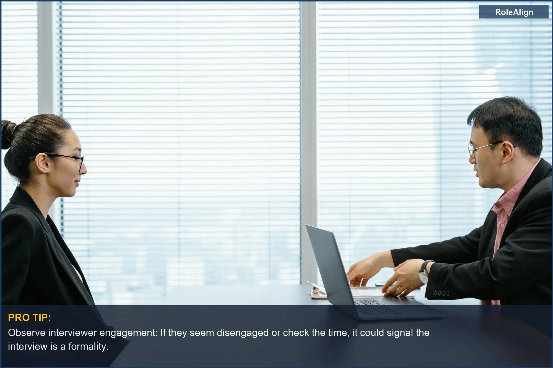 Two professionals in a modern office, one interviewer looking at the other during a job interview, suggesting the decision is already made.