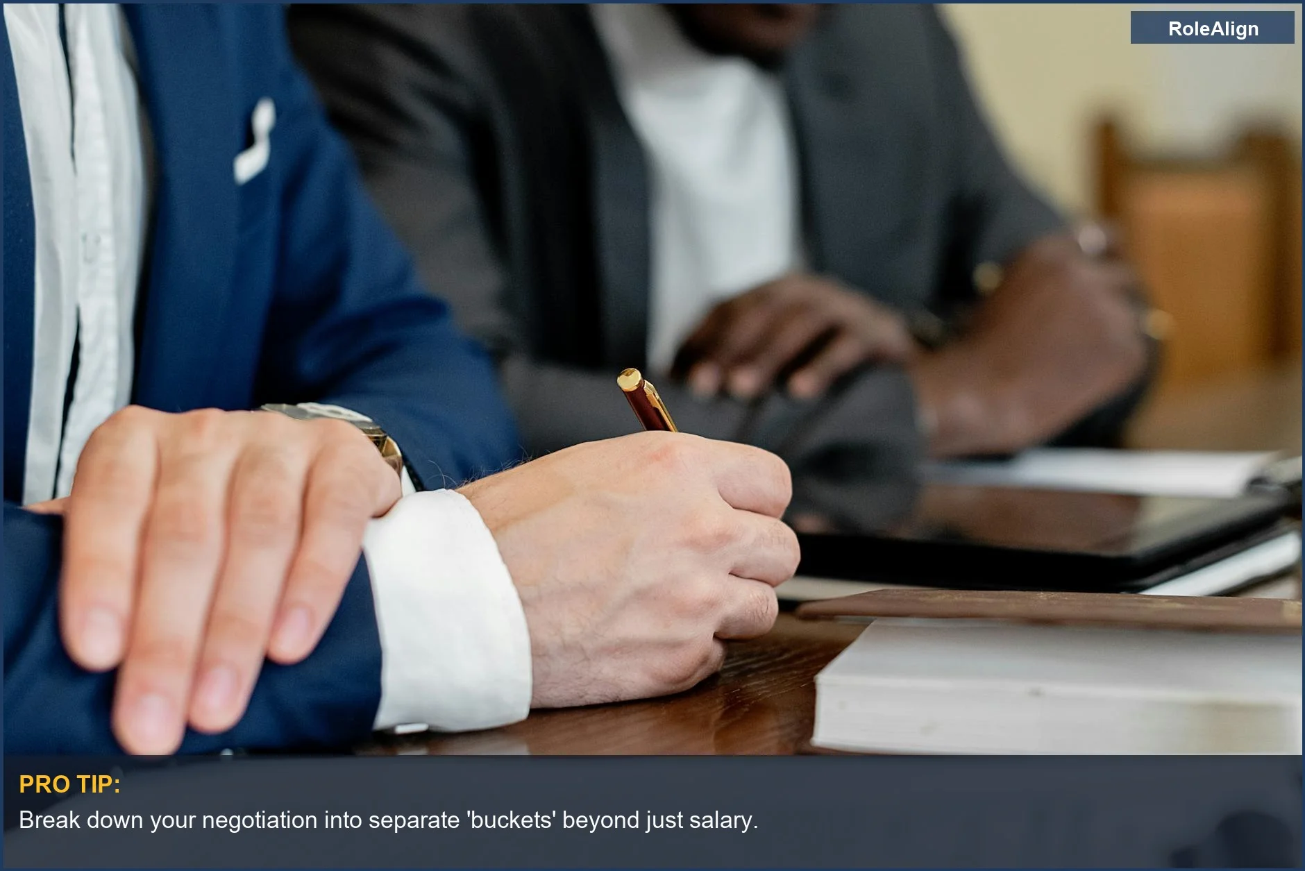Hands writing at a business meeting, symbolizing professional negotiation of compensation and benefits.