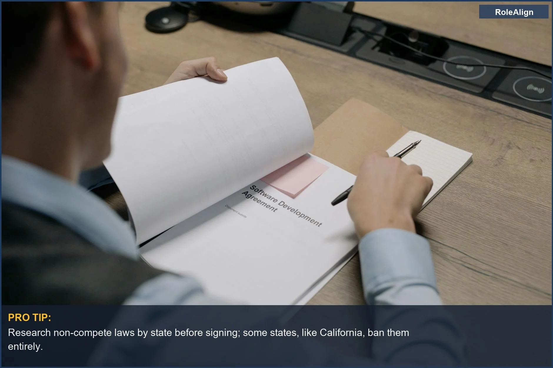 Close-up of business professional examining software development agreement, considering non-compete laws by state.