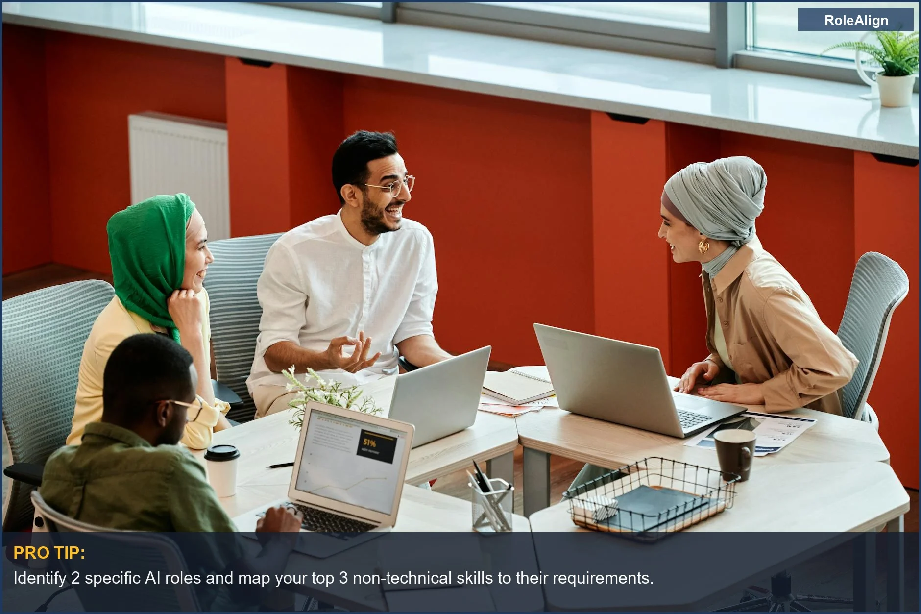 Coworkers discuss AI solutions on laptops, illustrating the importance of soft skills in AI career development.
