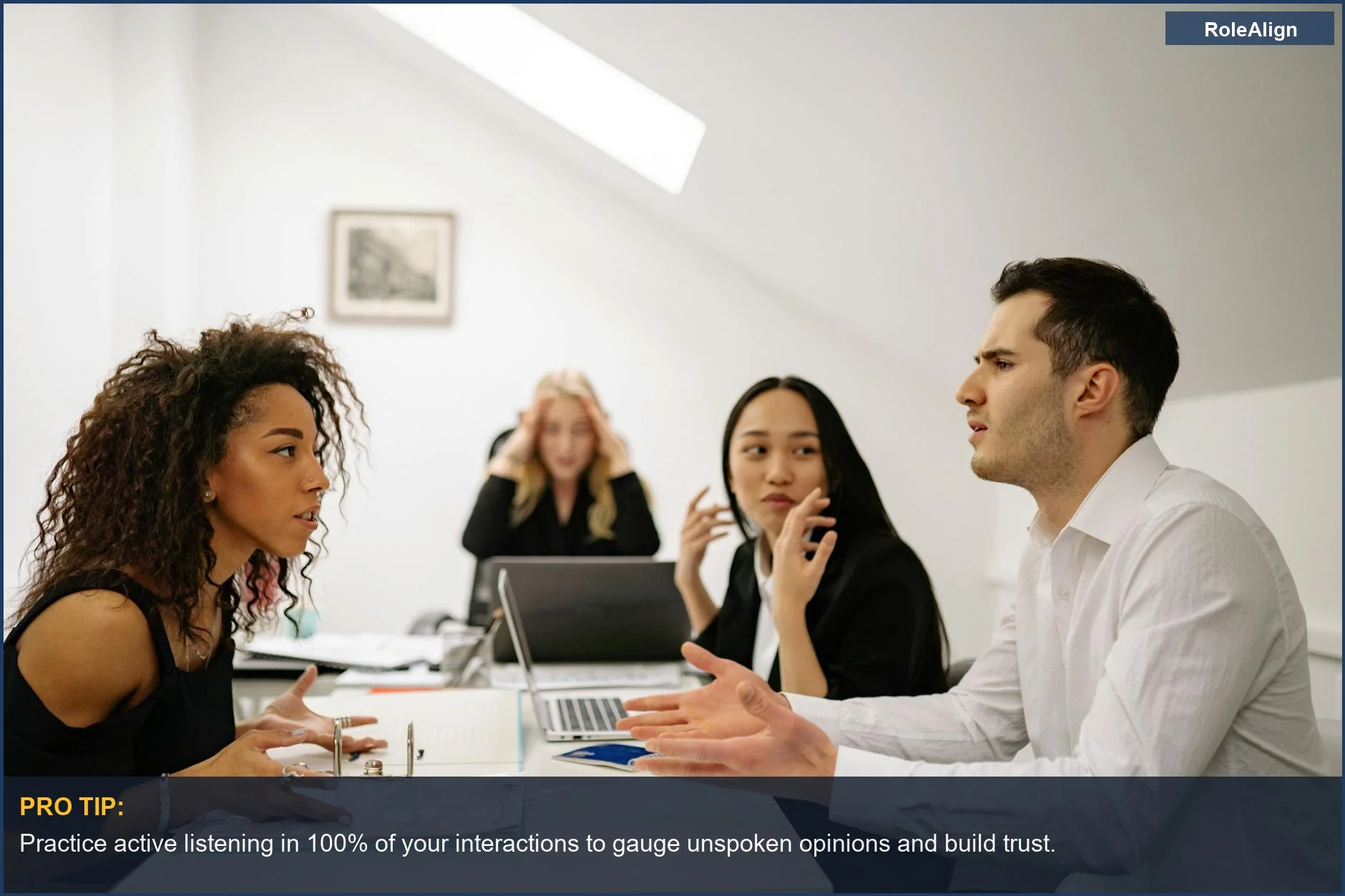 Multi-ethnic group in a lively office discussion, showcasing the emotional intelligence needed for office politics in hiring.