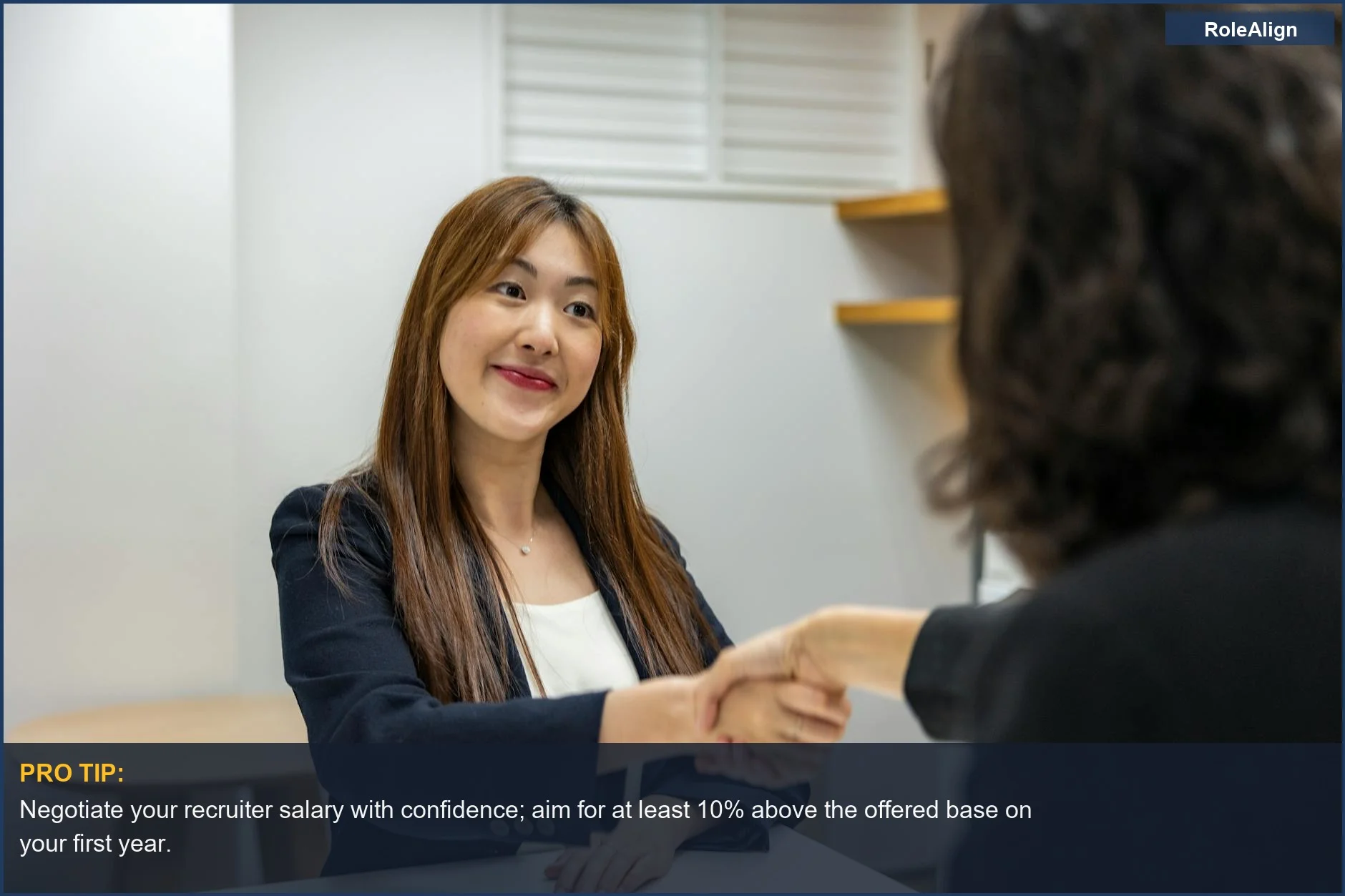 Businesswoman and recruiter shaking hands, symbolizing successful recruitment job salary negotiations in an office.