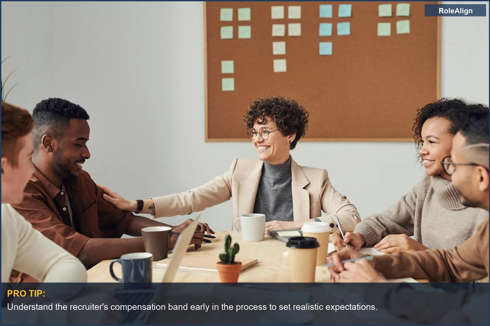 Business professionals in a modern office, collaborating and smiling during a meeting.